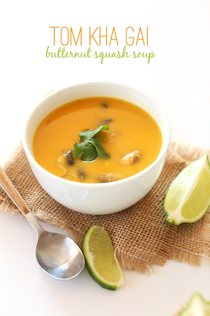 Bowl of Tom Kha Gai Butternut Squash Soup with fresh cilantro and lime wedges