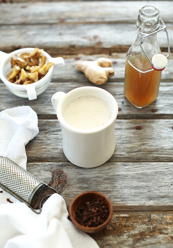 Fresh ginger syrup, strained ginger pieces, and a mug of our Ginger Tea Latte recipe