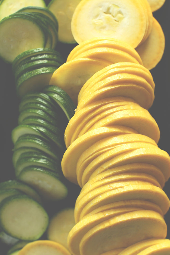 Freshly sliced zucchini and yellow squash rounds for making Zucchini Gratin