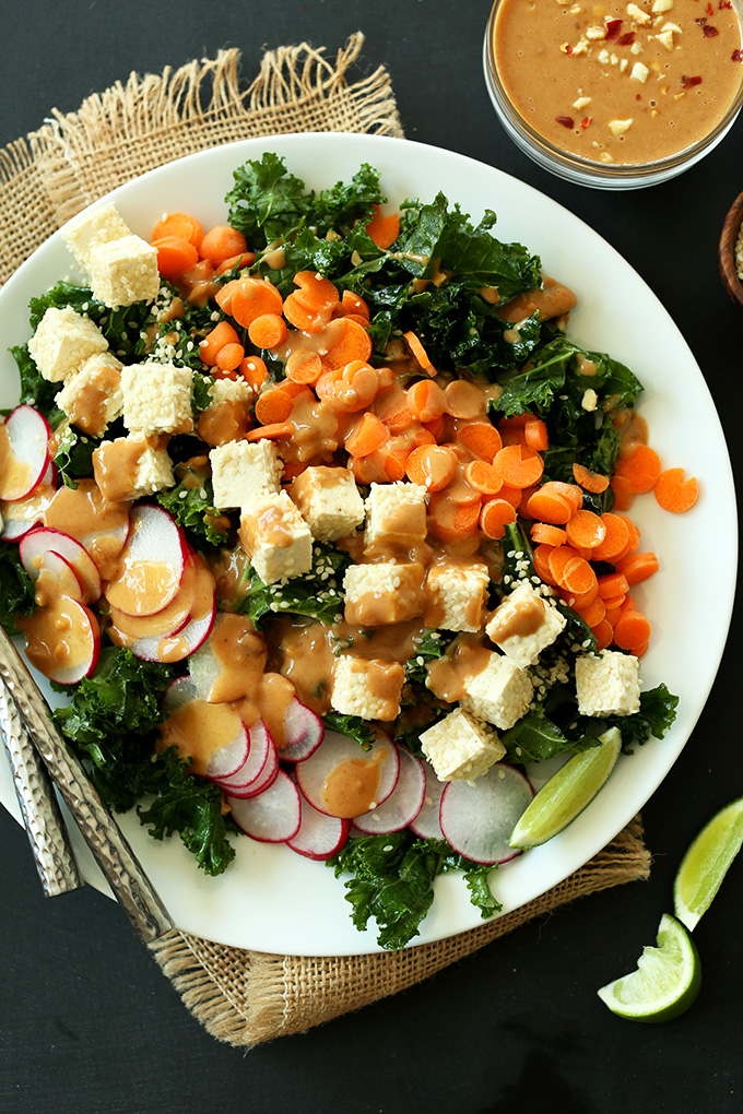 Plate of Thai Kale Salad made with radishes, tofu, carrots, and kale