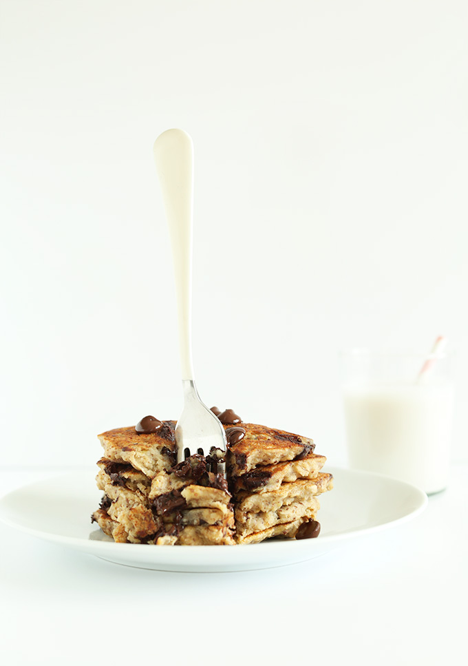 Fork standing up in a stack of Oatmeal Chocolate Chip Cookie Pancakes