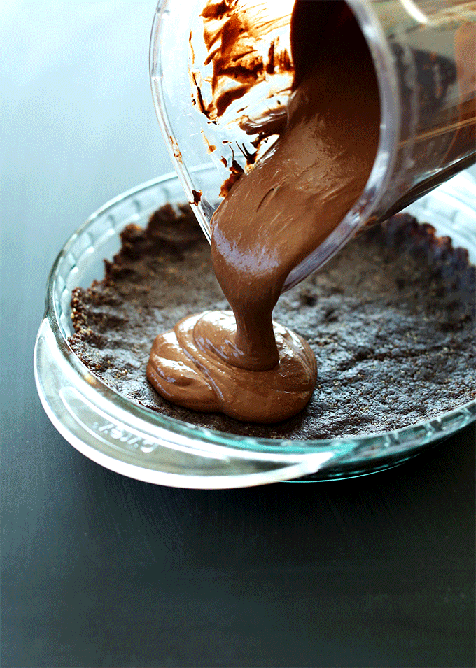 Pouring Vegan Chocolate Pie Filling into a Brownie Crust
