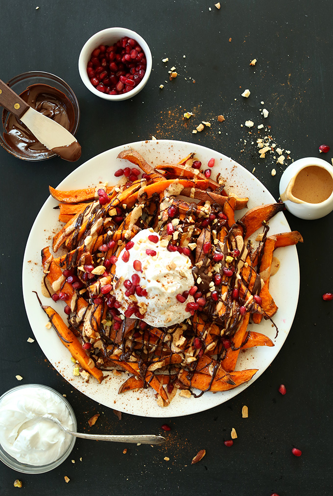 Big plate of Sweet Potato Superfood Dessert Fries topped with chocolate sauce, peanut butter and more