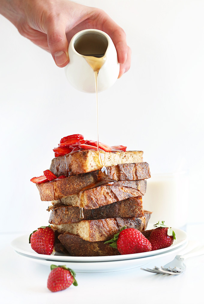 Pouring agave onto a stack of our Vegan French Toast recipe