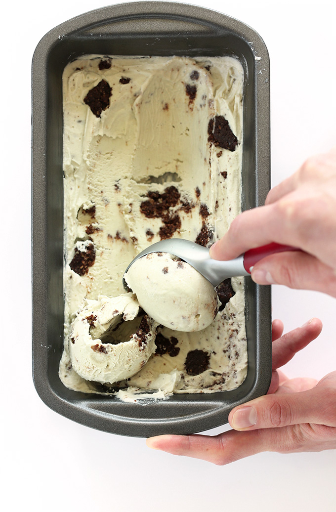 Using an ice cream scooper to grab a scoop of Creamy Vegan Mint Ice Cream