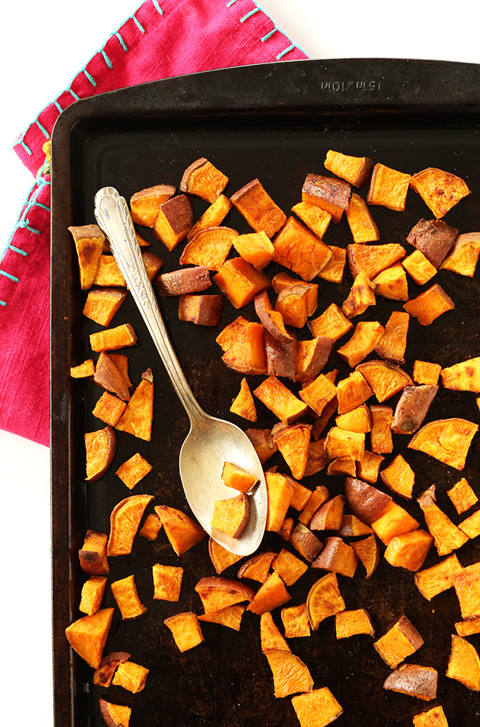 Baking sheet filled with freshly roasted sweet potato cubes for Mexican Roasted Sweet Potatoes