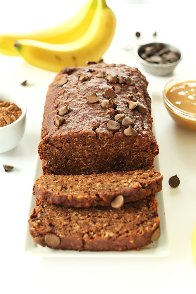 Partially sliced loaf of gluten-free vegan Peanut Butter Banana Chocolate Snack Bread
