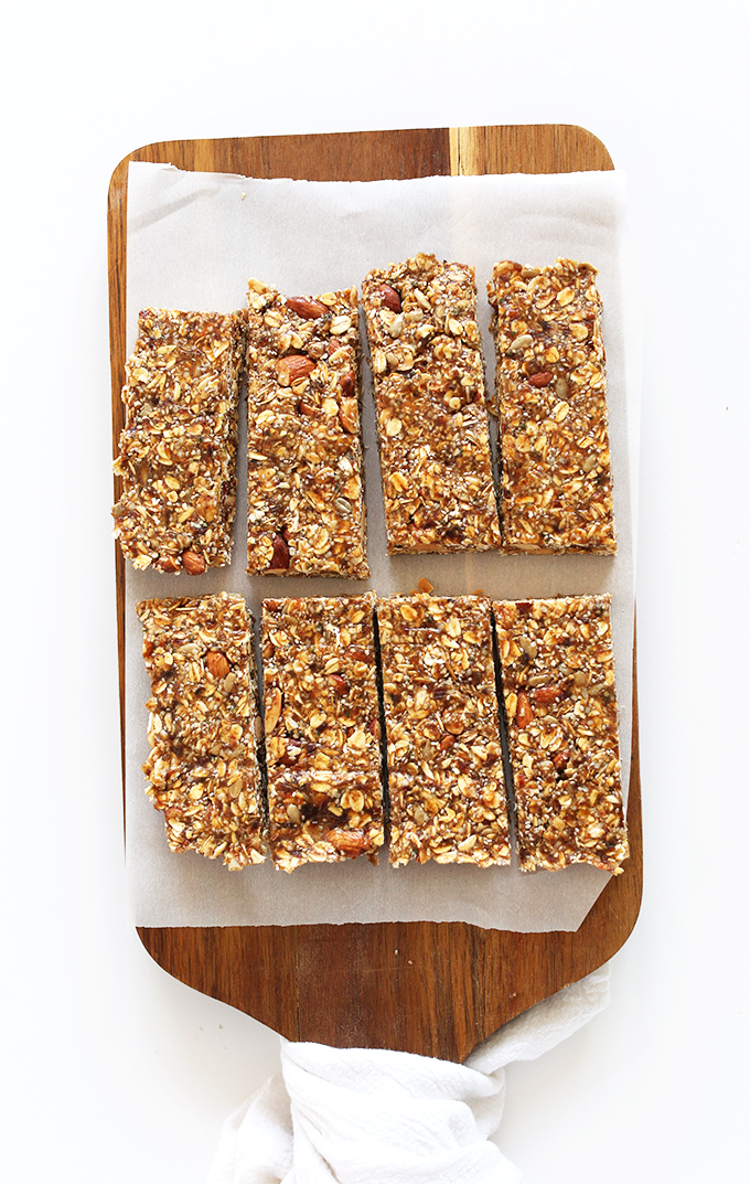 Freshly baked and sliced homemade vegan granola bars on a cutting board