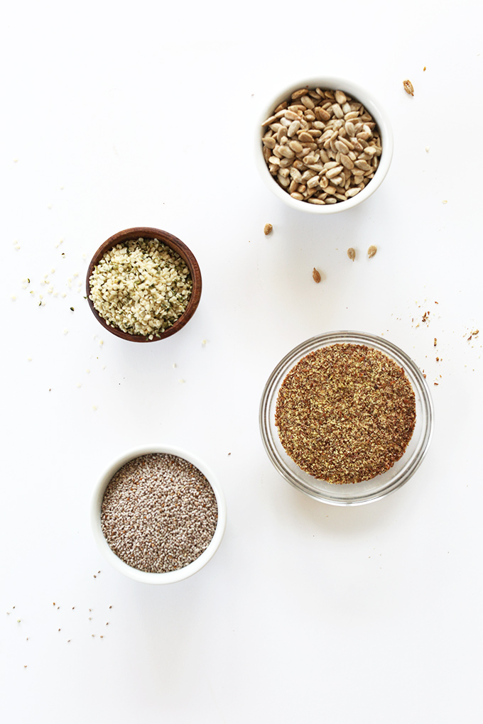 Bowls of sunflower, hemp, flax, and chia seeds for making homemade vegan granola bars