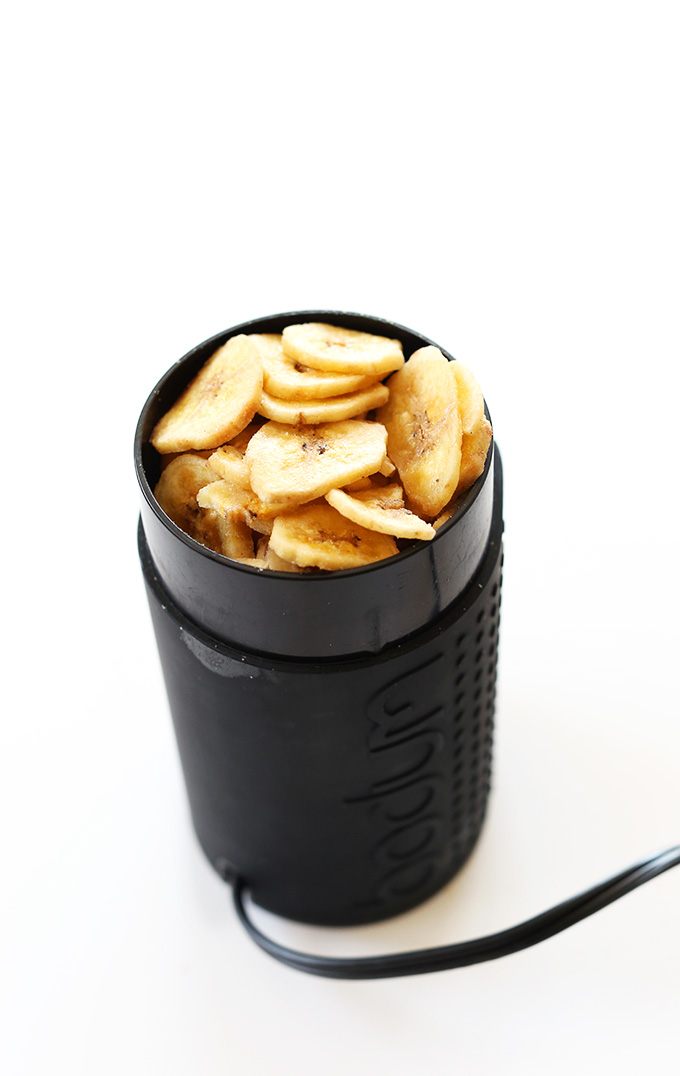 Spice grinder filled with banana chips for making banana powder