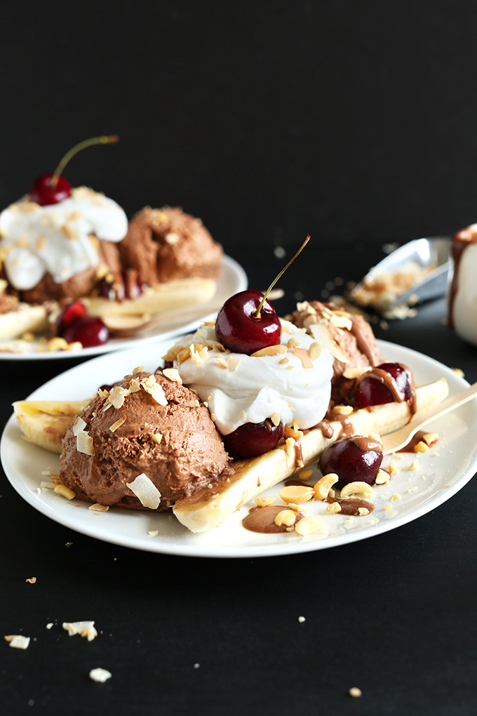 Close up shot of a Vegan Banana Split loaded with chocolate ice cream and cherries