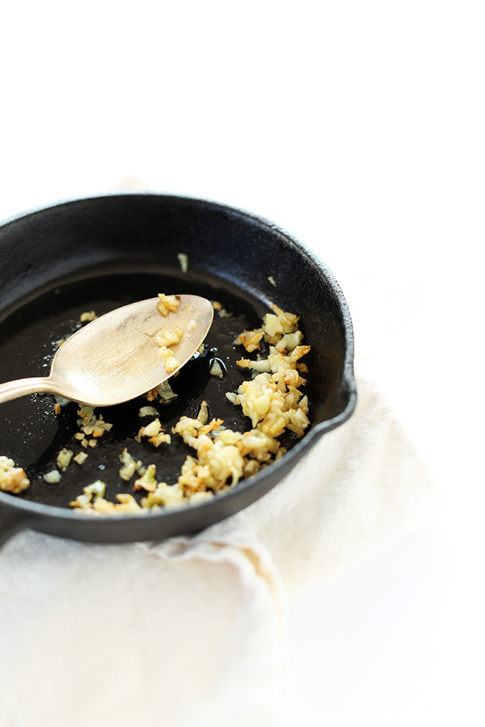 Mini cast-iron skillet with lightly browned minced garlic