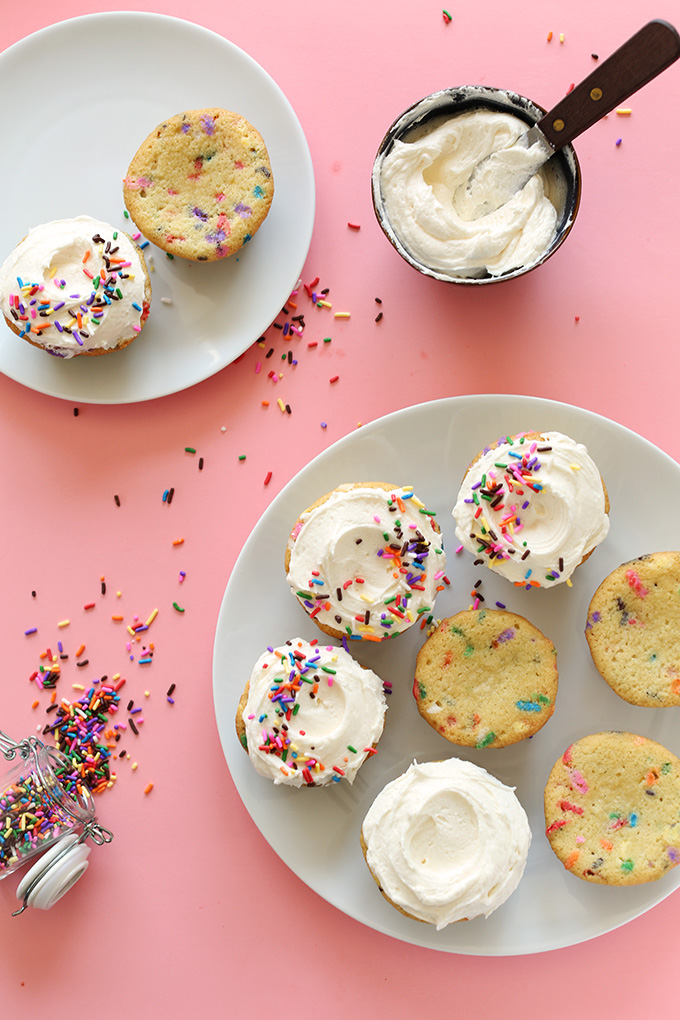 Plates of partially frosted Vegan Funfetti Cupcakes