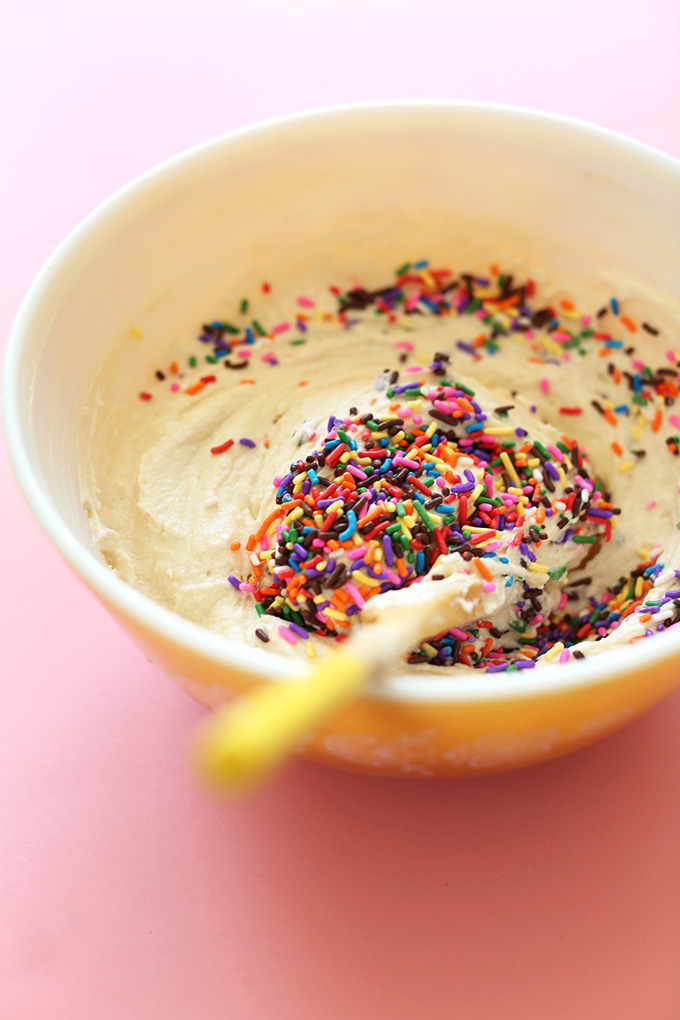Stirring sprinkles into Vegan Funfetti Cupcake batter