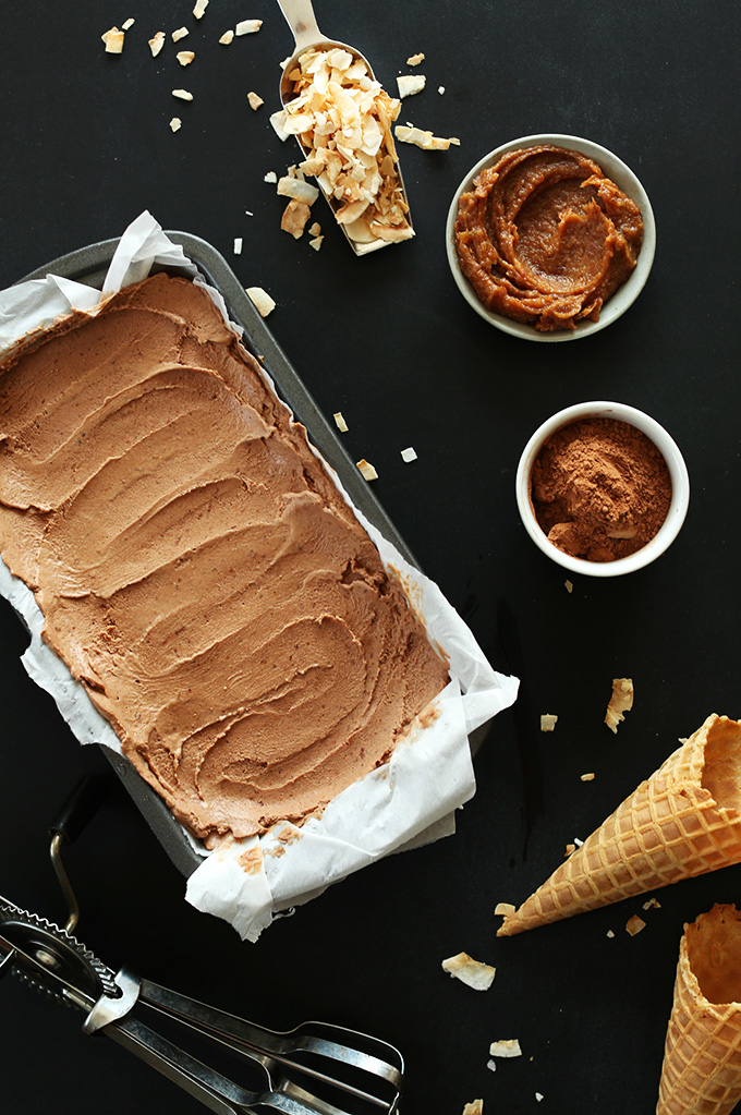 Pan of super creamy No-Churn Vegan Chocolate Ice Cream surrounded by date caramel and other ingredients