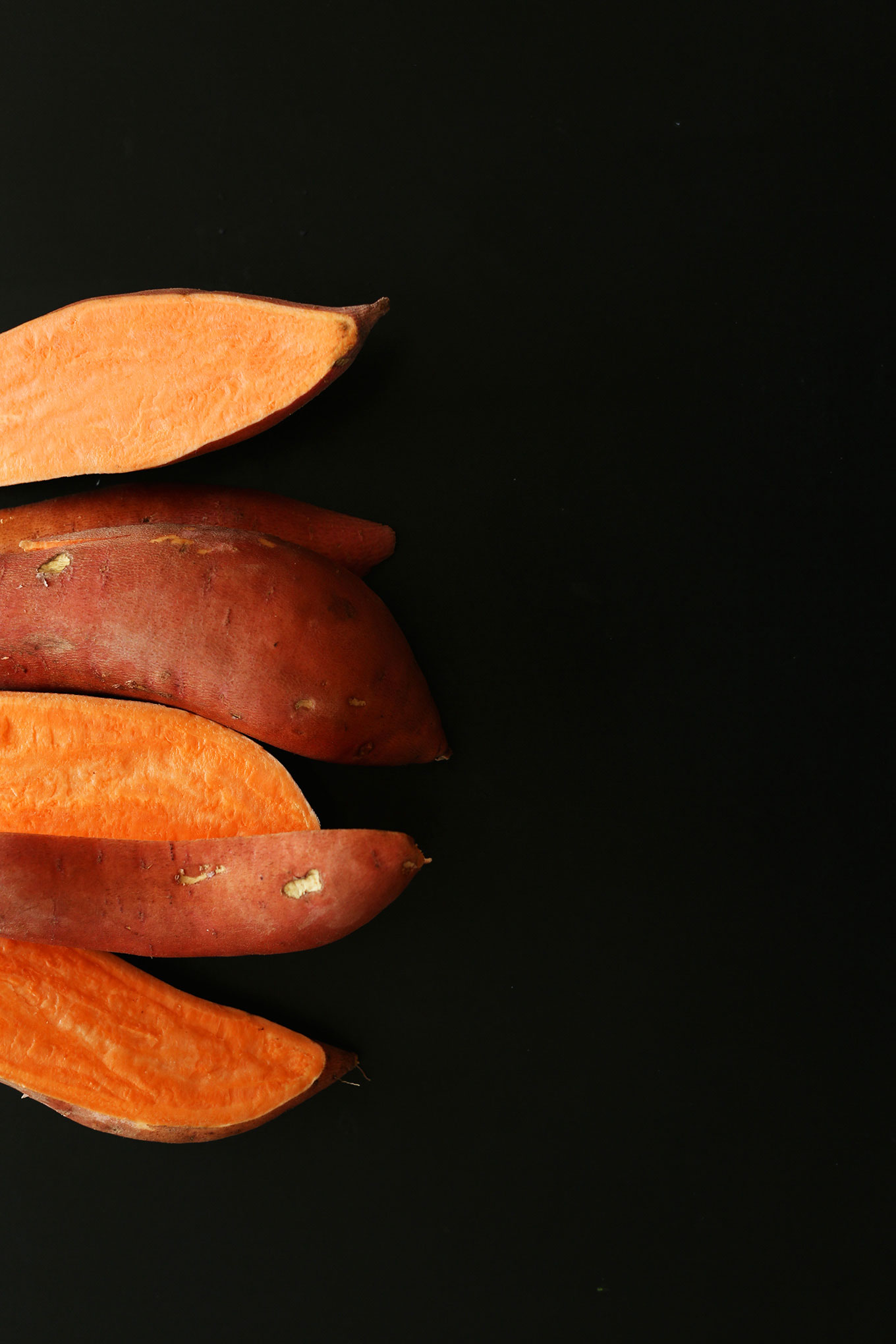Several halved skin-on sweet potatoes
