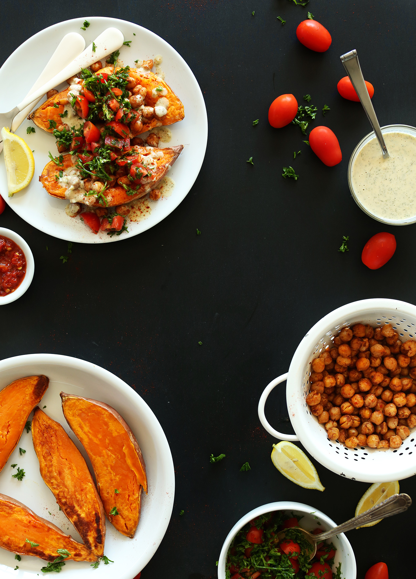 Plate of gluten-free vegan Mediterranean Baked Sweet Potatoes alongside ingredients for making them