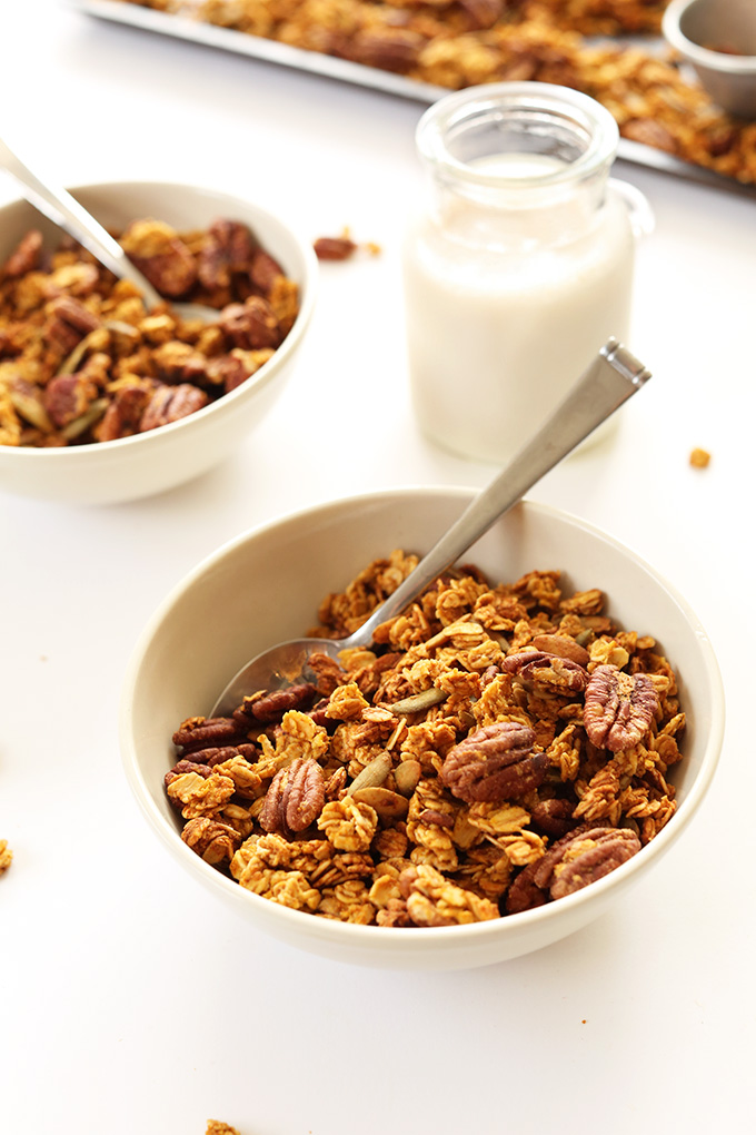 Bowls of Pumpkin Pecan Granola and a side of almond milk