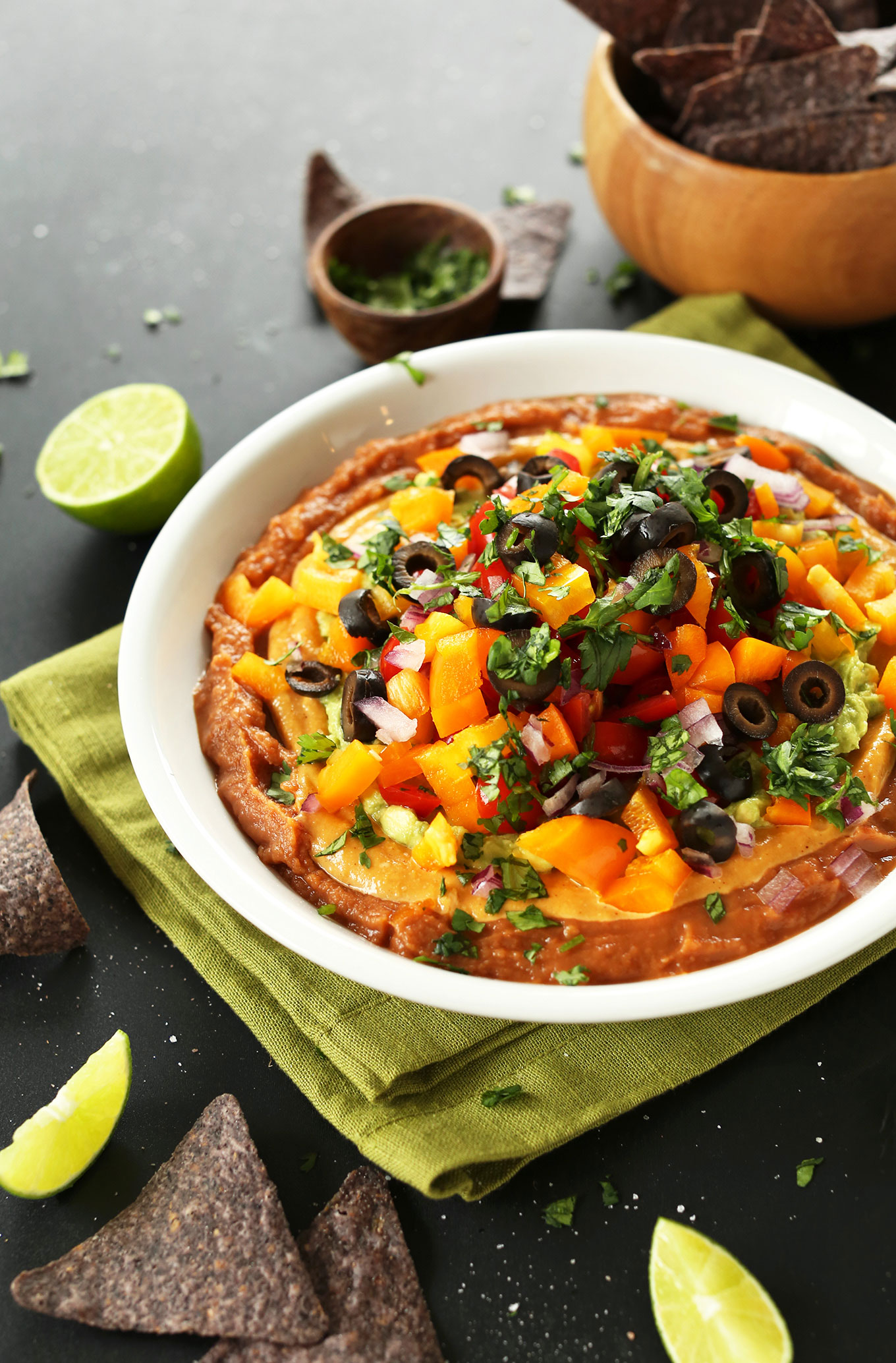 Bowl of our Mexican 7-Layer Dip loaded with vegetables for a healthy vegan snack