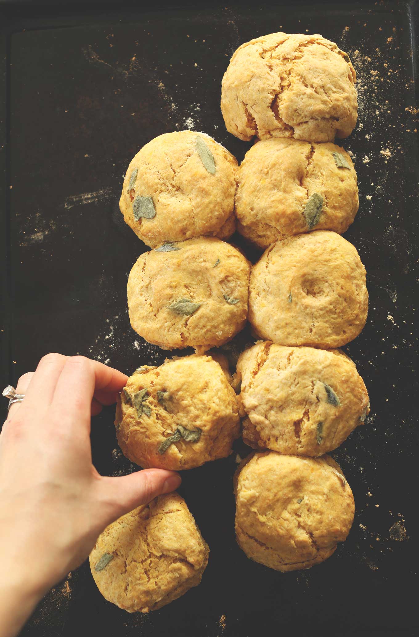 Grabbing one of our Pumpkin Sage Biscuits from the baking sheet