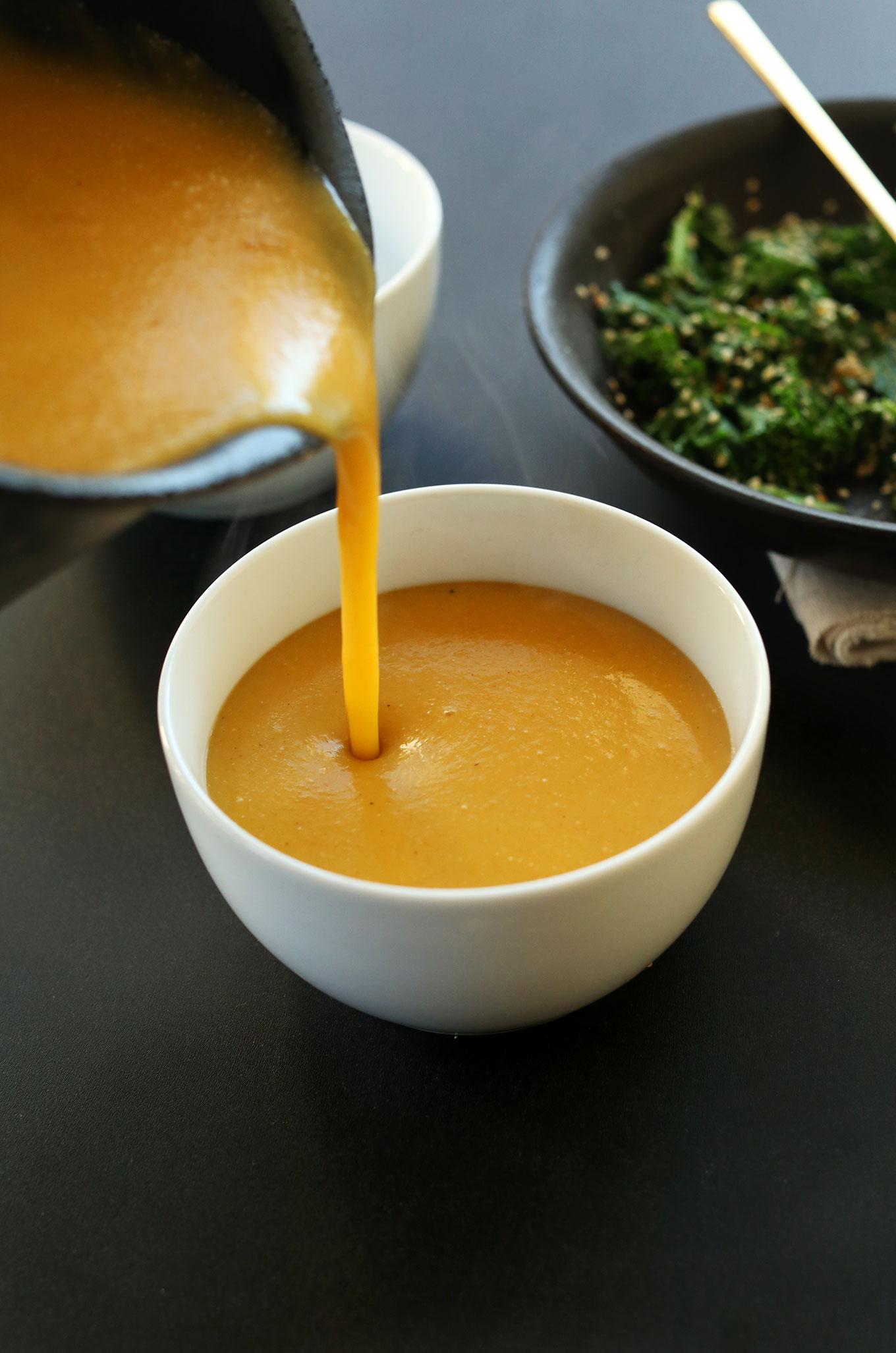 Pouring gluten-free vegan Pumpkin Soup into a bowl