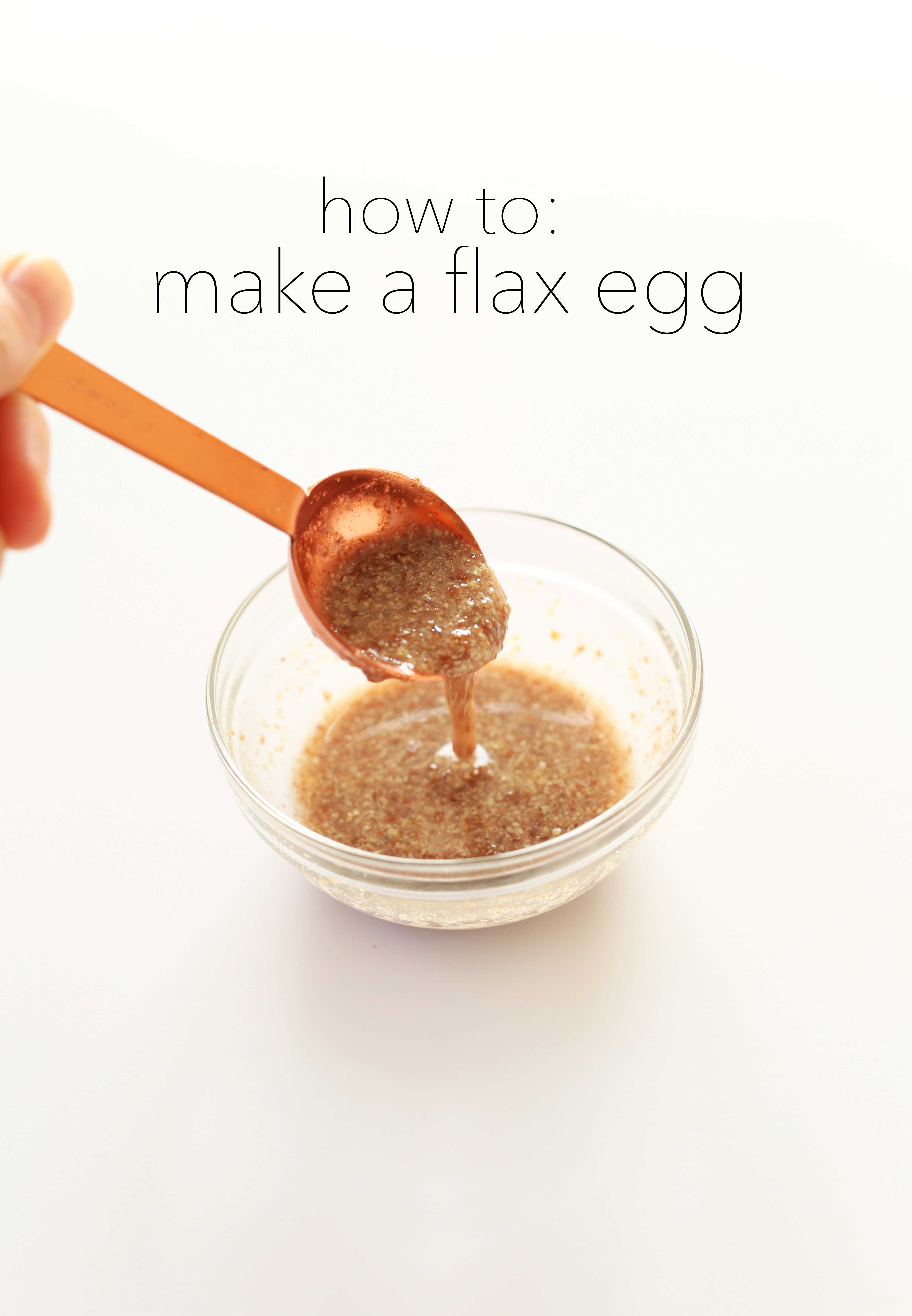 Gooey flax egg dripping from a measuring spoon into a bowl