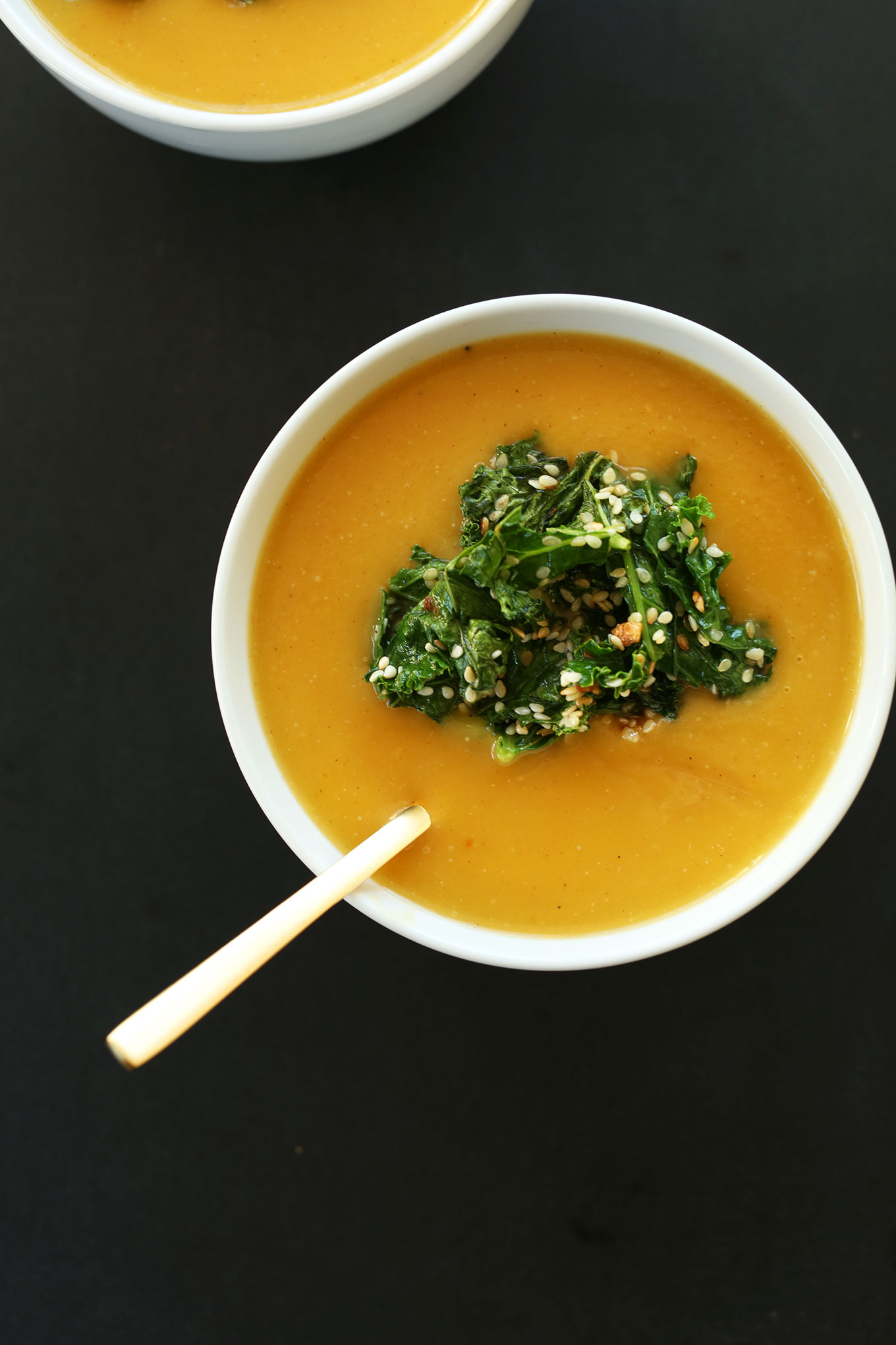 Bowl of savory homemade pumpkin soup with sesame kale