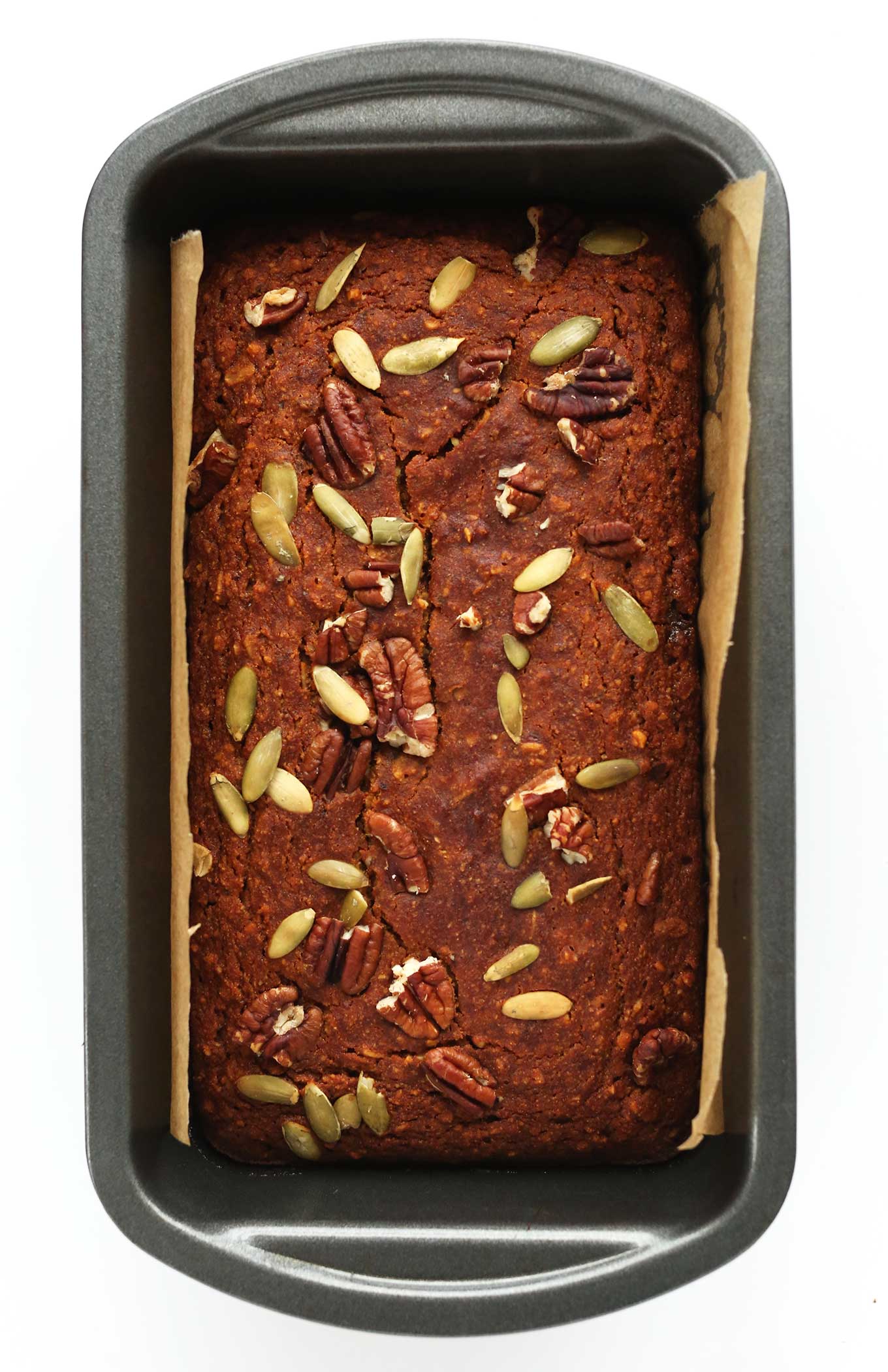 Parchment-lined baking pan filled with Vegan Gluten-Free Pumpkin Bread