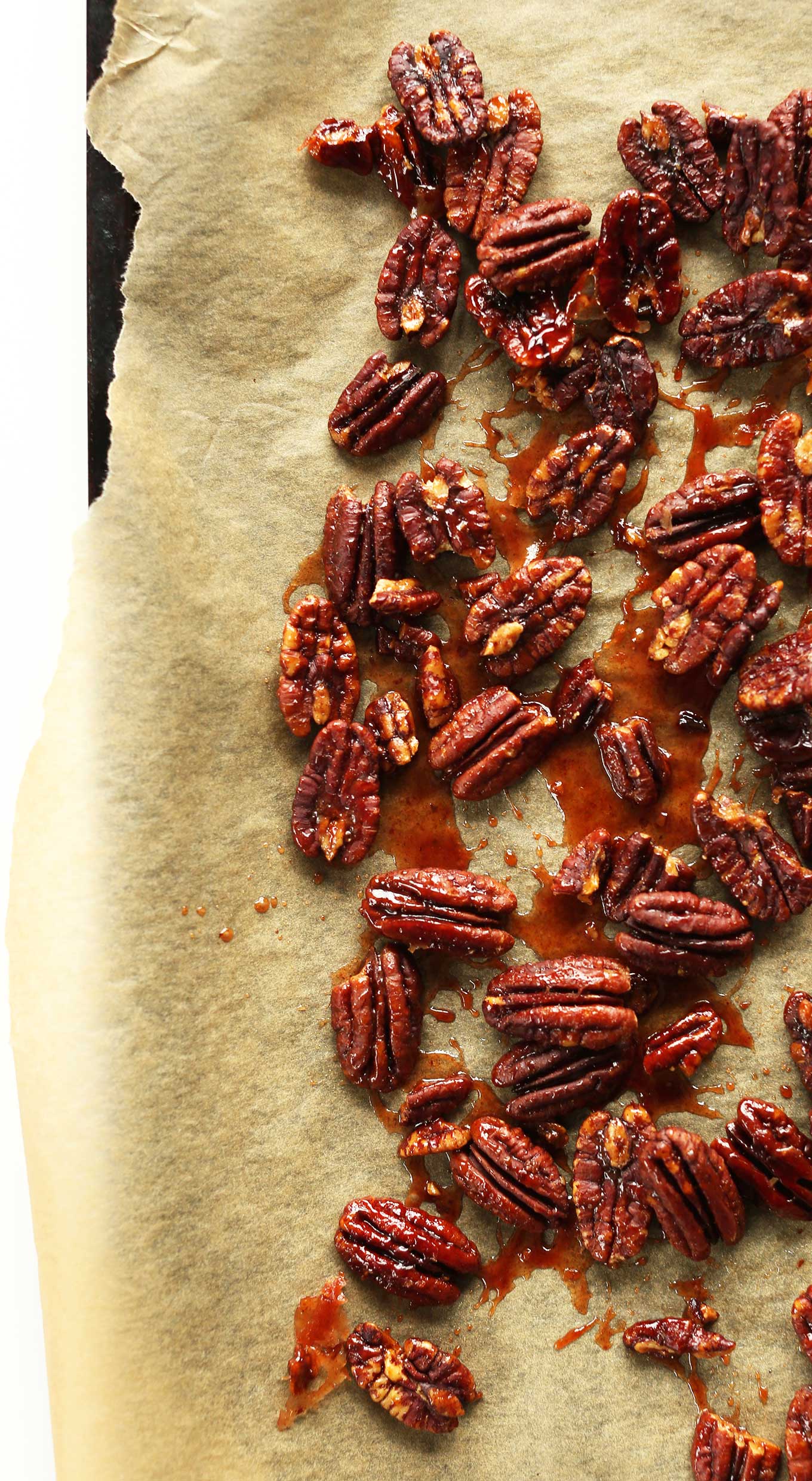 Parchment-lined baking sheet with Vegan Maple Roasted Pecans
