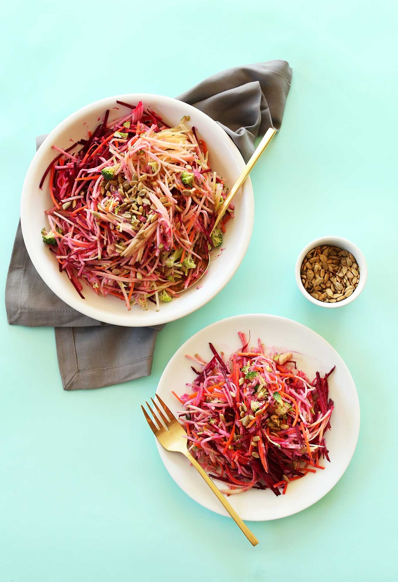 Plate and big bowl of colorful fall slaw with a tangy vegan dressing