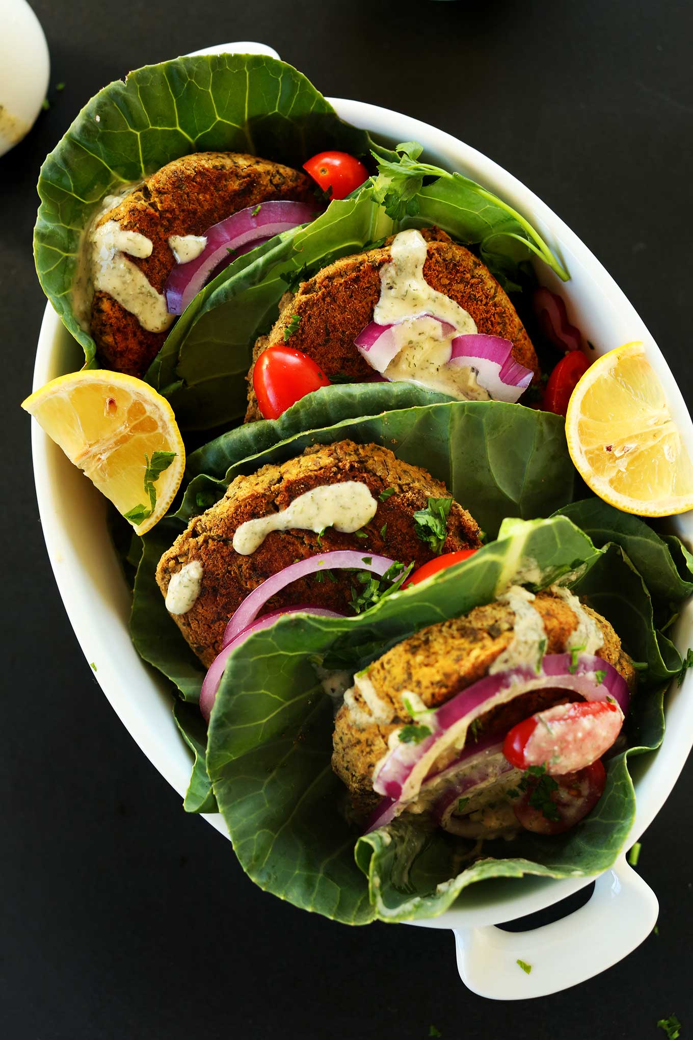 Healthy, Simple BAKED Falafel Burgers! Perfect on greens or pita with a simple hummus-garlic sauce! #vegan