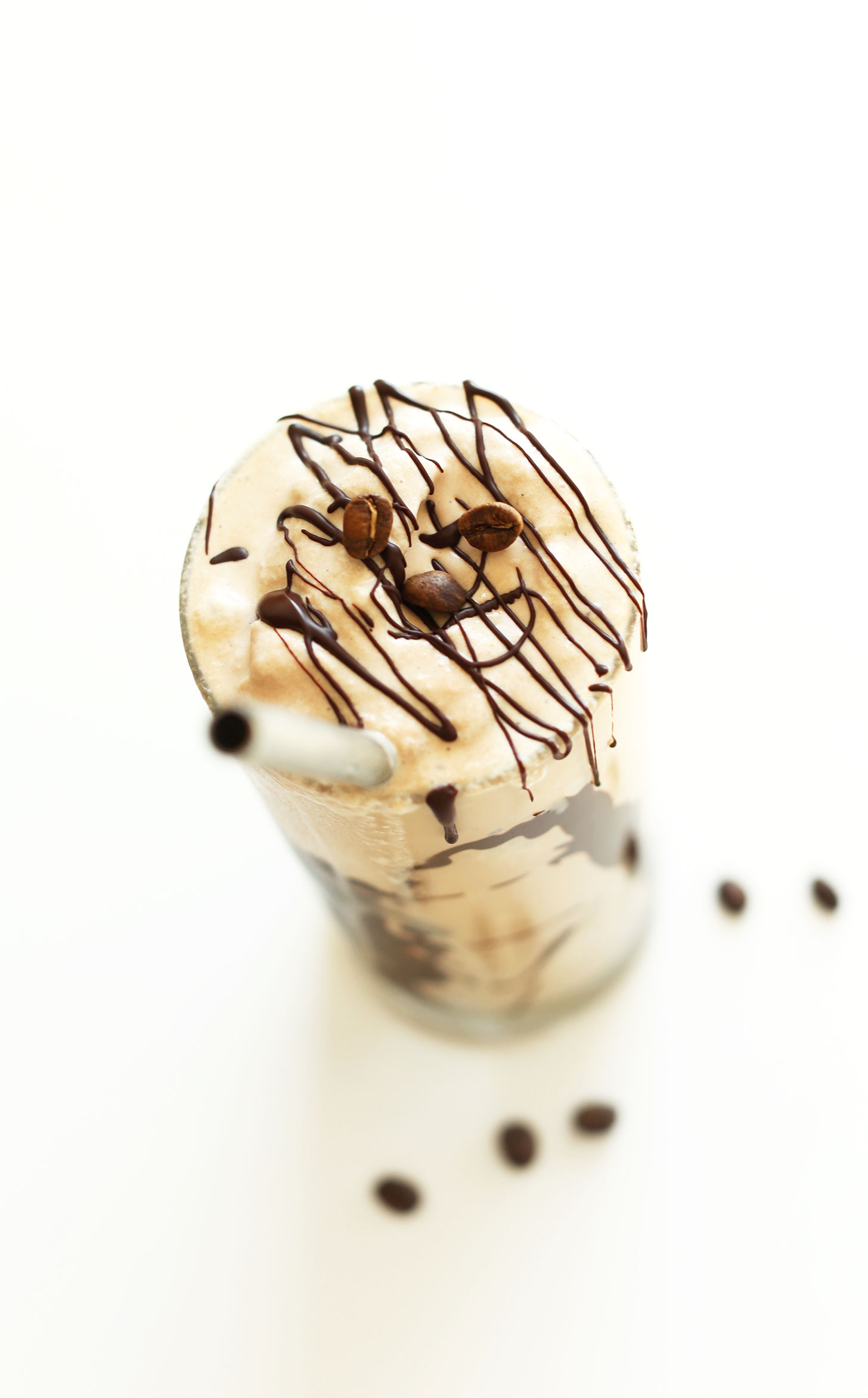 Glass of our vegan mocha shake topped with a chocolate magic shell drizzle 
