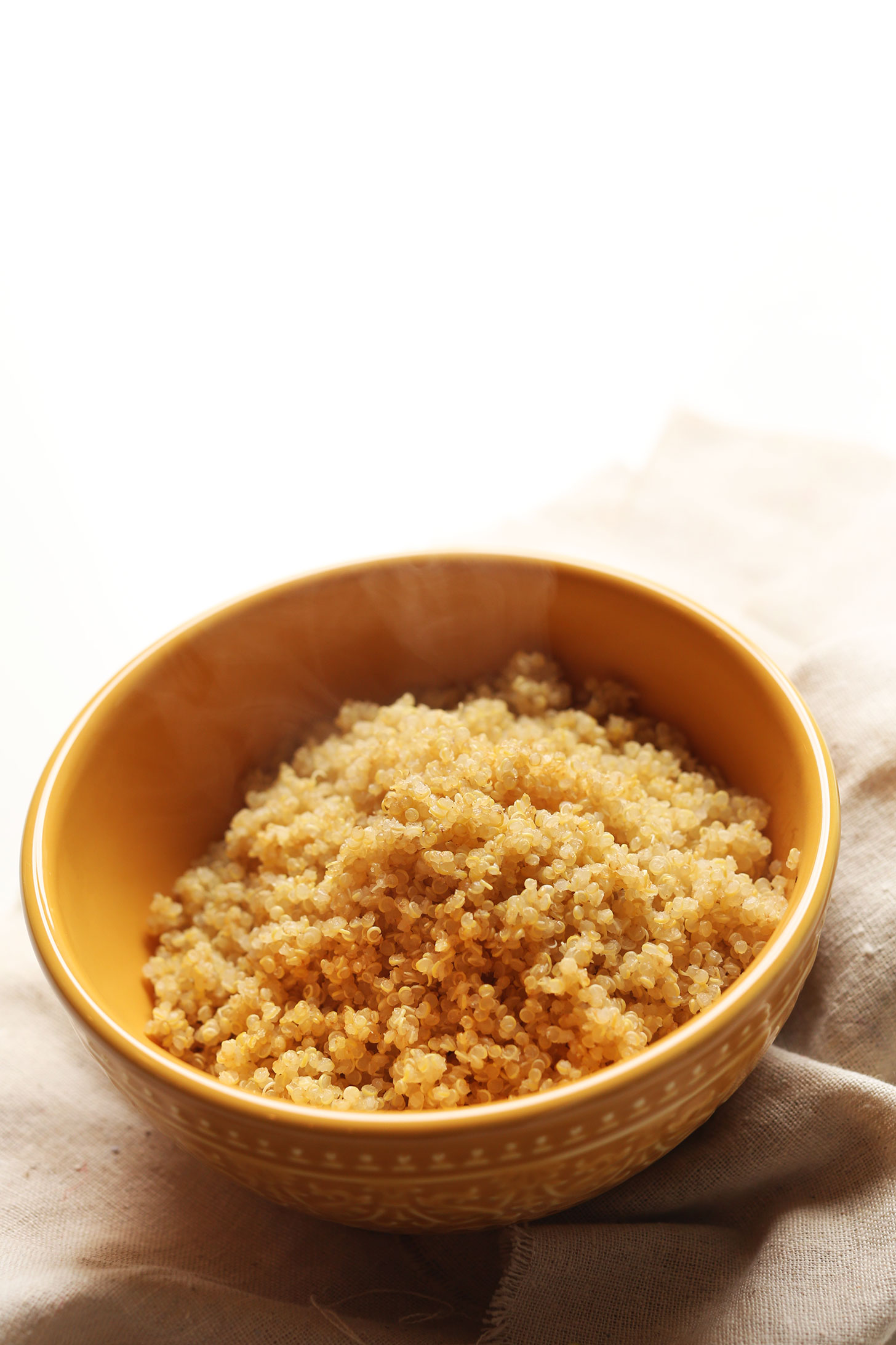 Bowl of freshly cooked quinoa prepared using our favorite method for fluffy quinoa