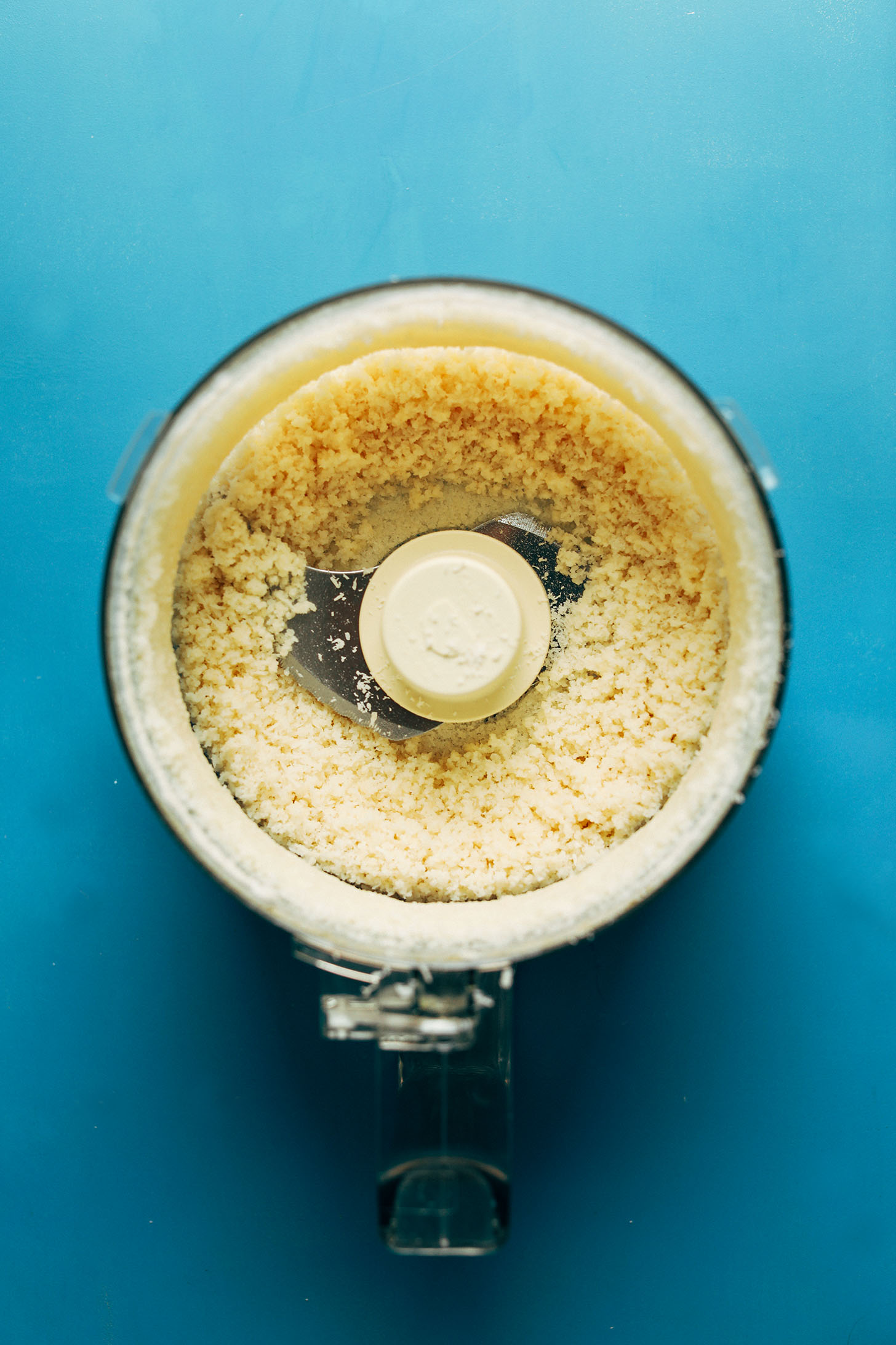 Food processor with a batch of partially-made coconut butter