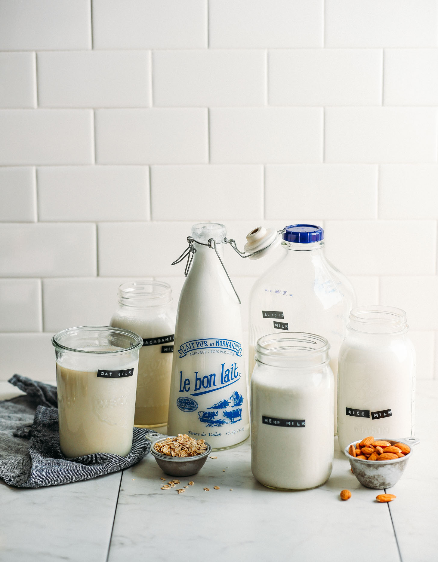 Jugs of DIY dairy-free milks including homemade rice milk