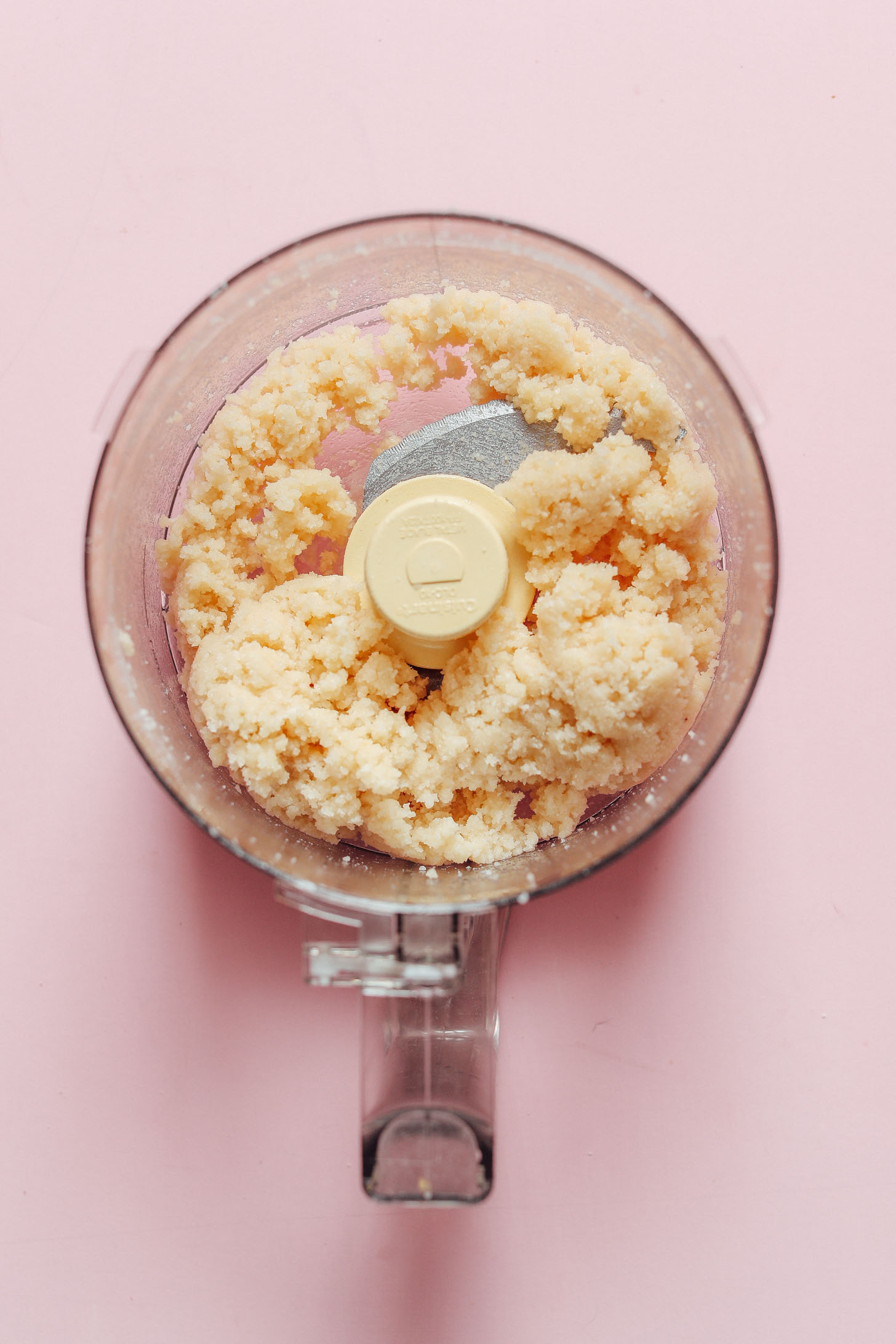 Food processor with freshly mixed dough for our Coconut Snowball Cookies recipe
