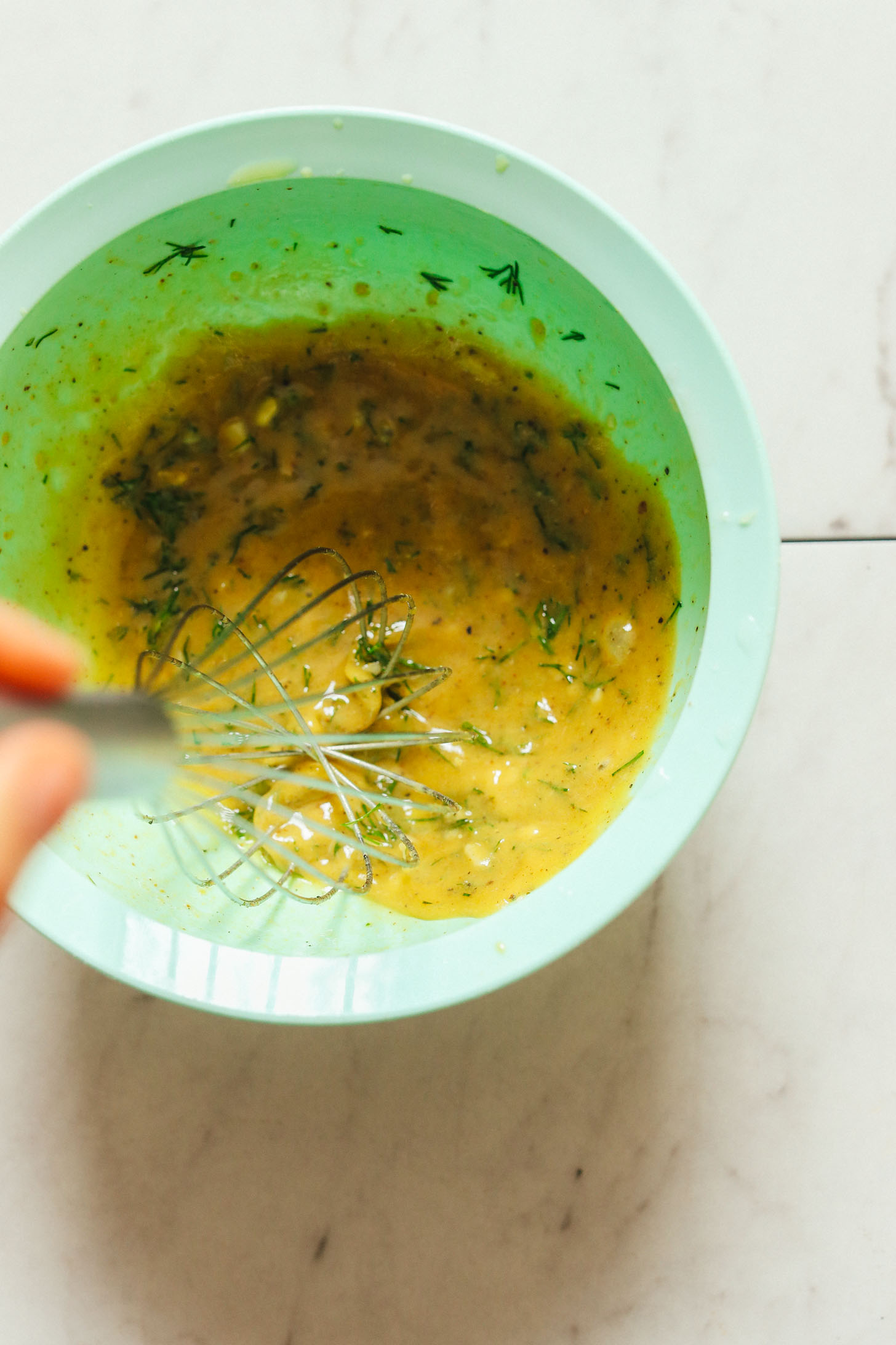 Whisking together homemade dressing for French Style Potato Salad