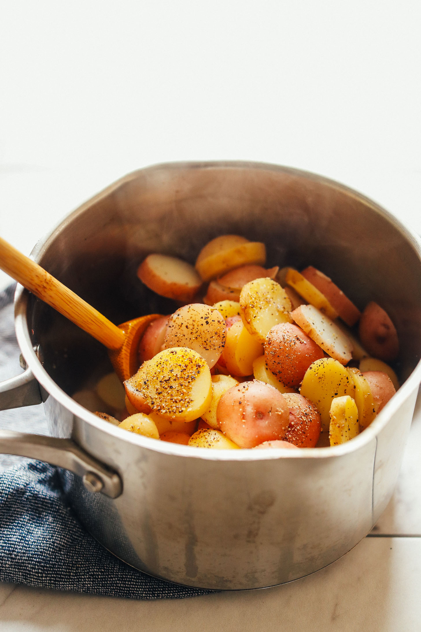Saucepan filled with freshly cooked potatoes for homemade potato salad