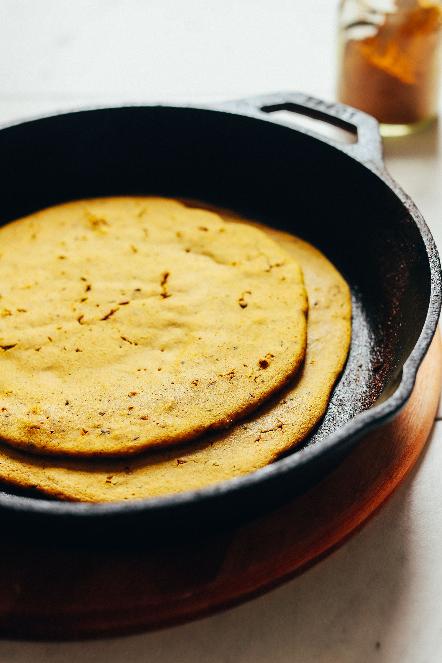 Freshly cooked Curried Socca bread resting in a skillet