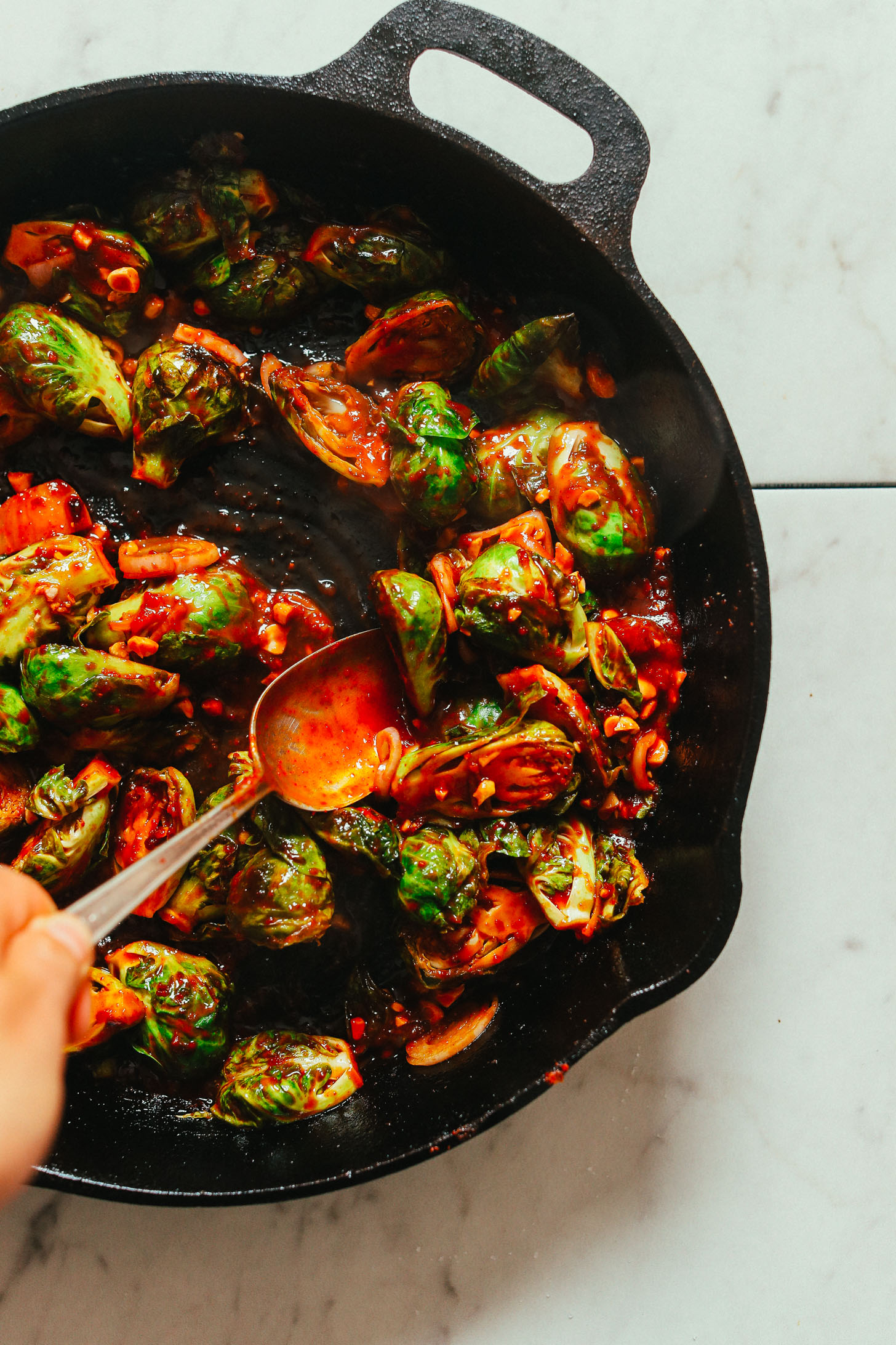 Cast-iron skillet filled with our vegan Gochujang Brussels Sprouts recipe