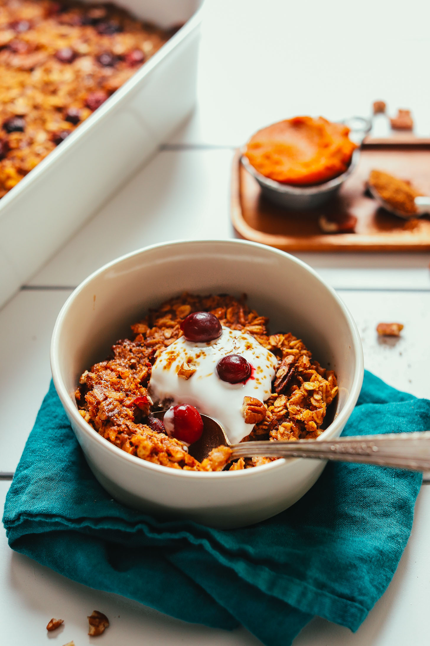 Bowl of our delicious Vegan Pumpkin Baked Oatmeal recipe topped with coconut whip