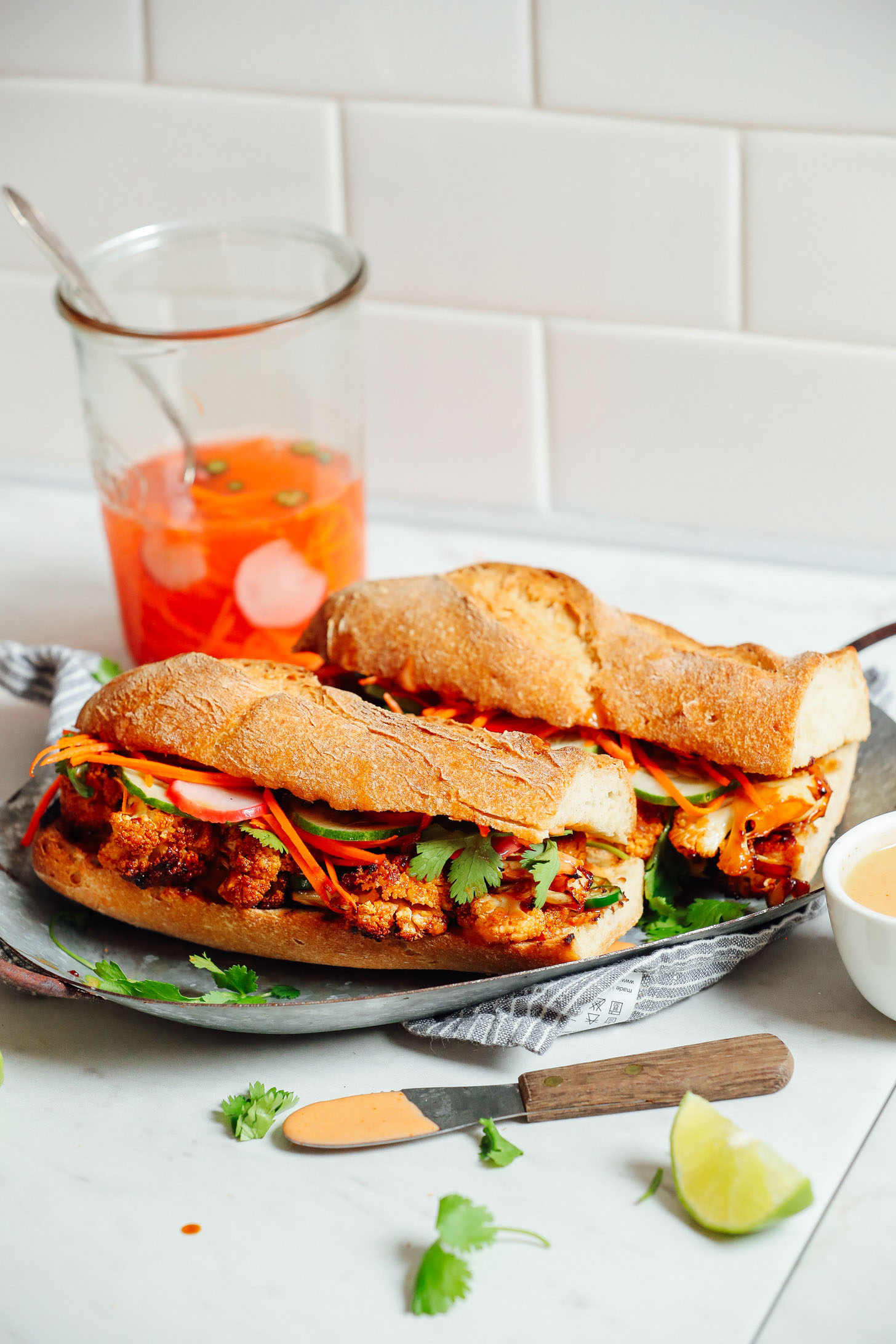 Plate displaying two gluten-free vegan Cauliflower Banh Mi sandwiches