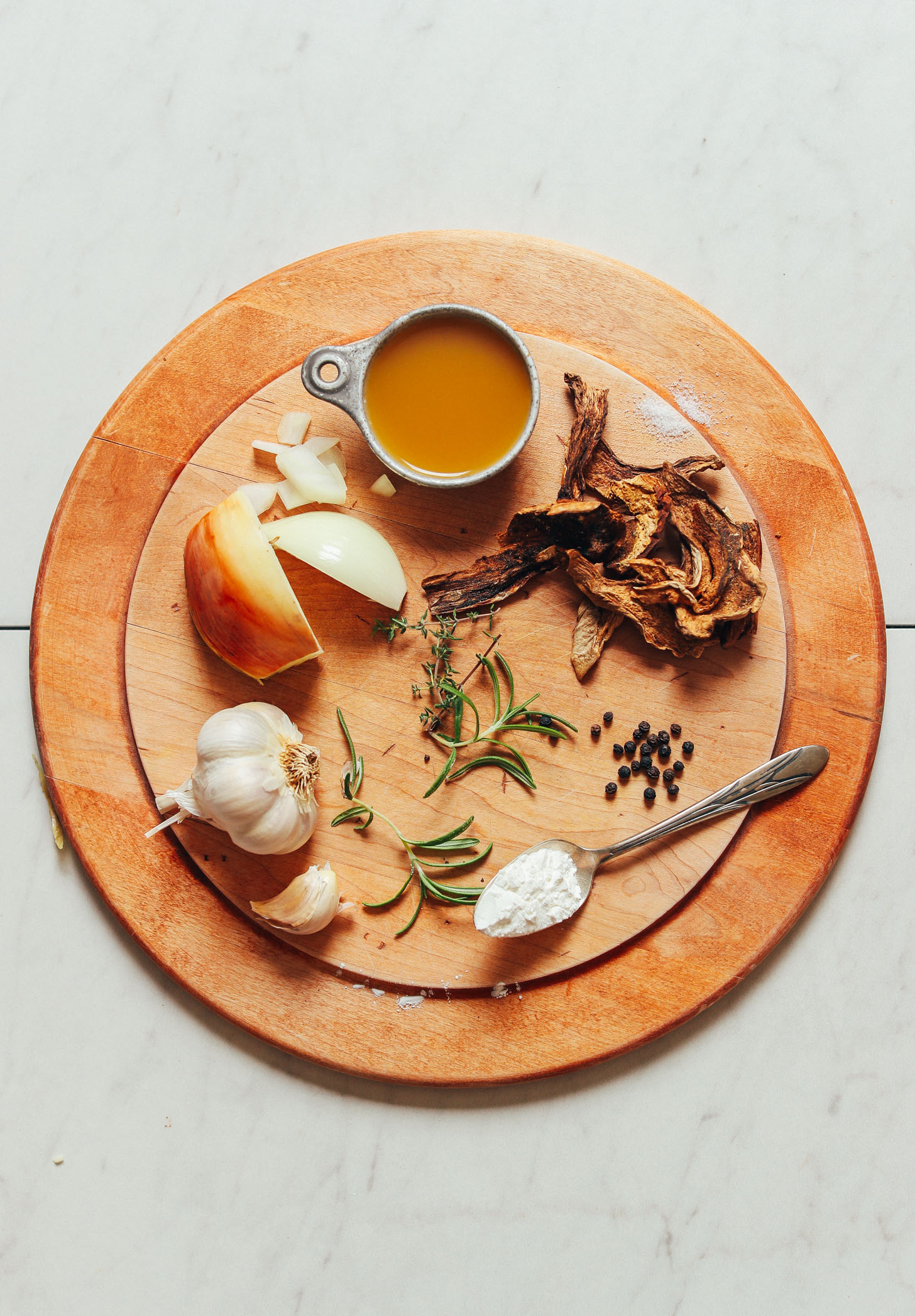 Wood cutting board with ingredients for making our simple homemade vegan gravy recipe