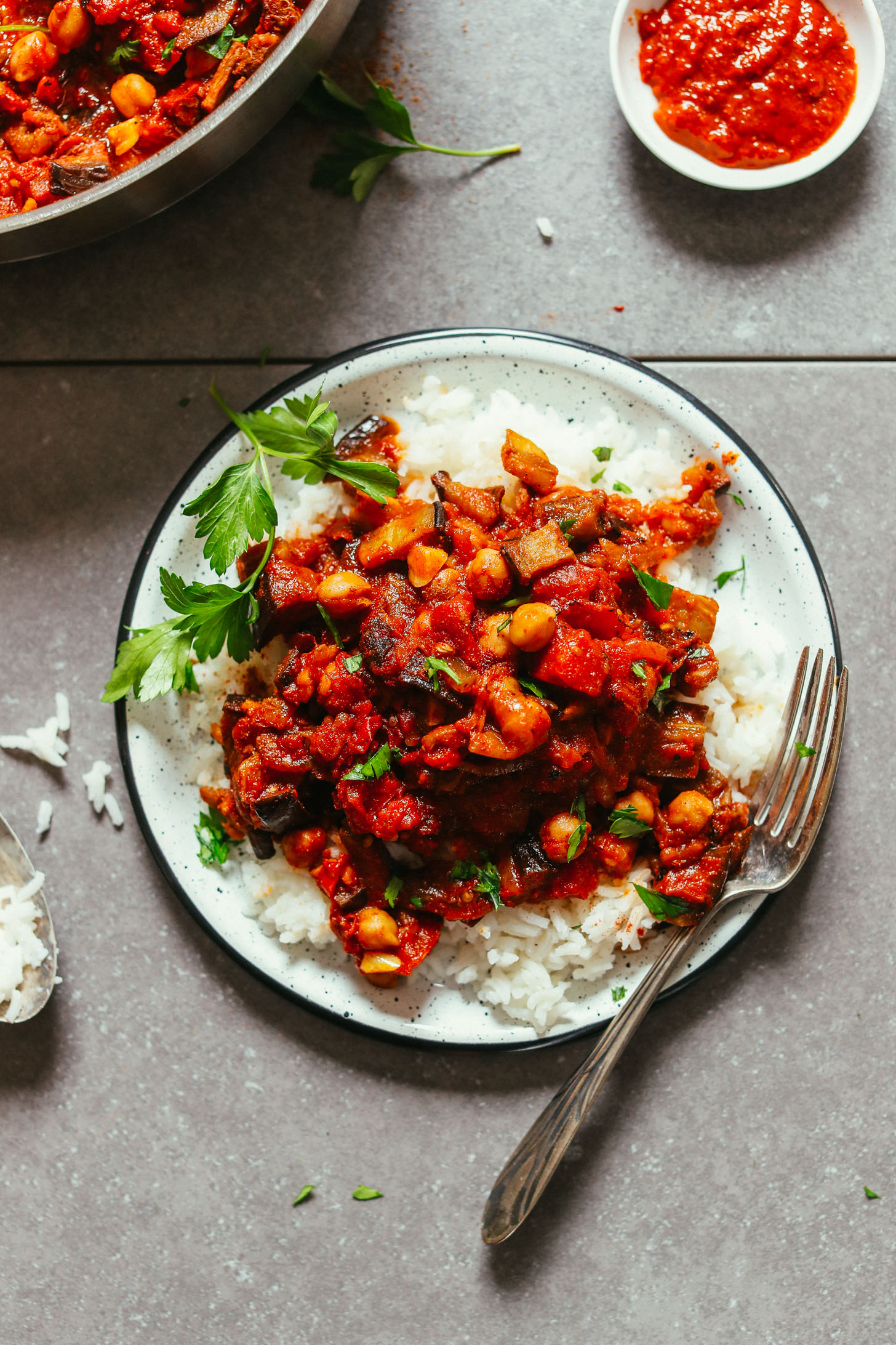 Plate of rice topped with vegan Moroccan-Spiced Roasted Eggplant & Tomato Stew