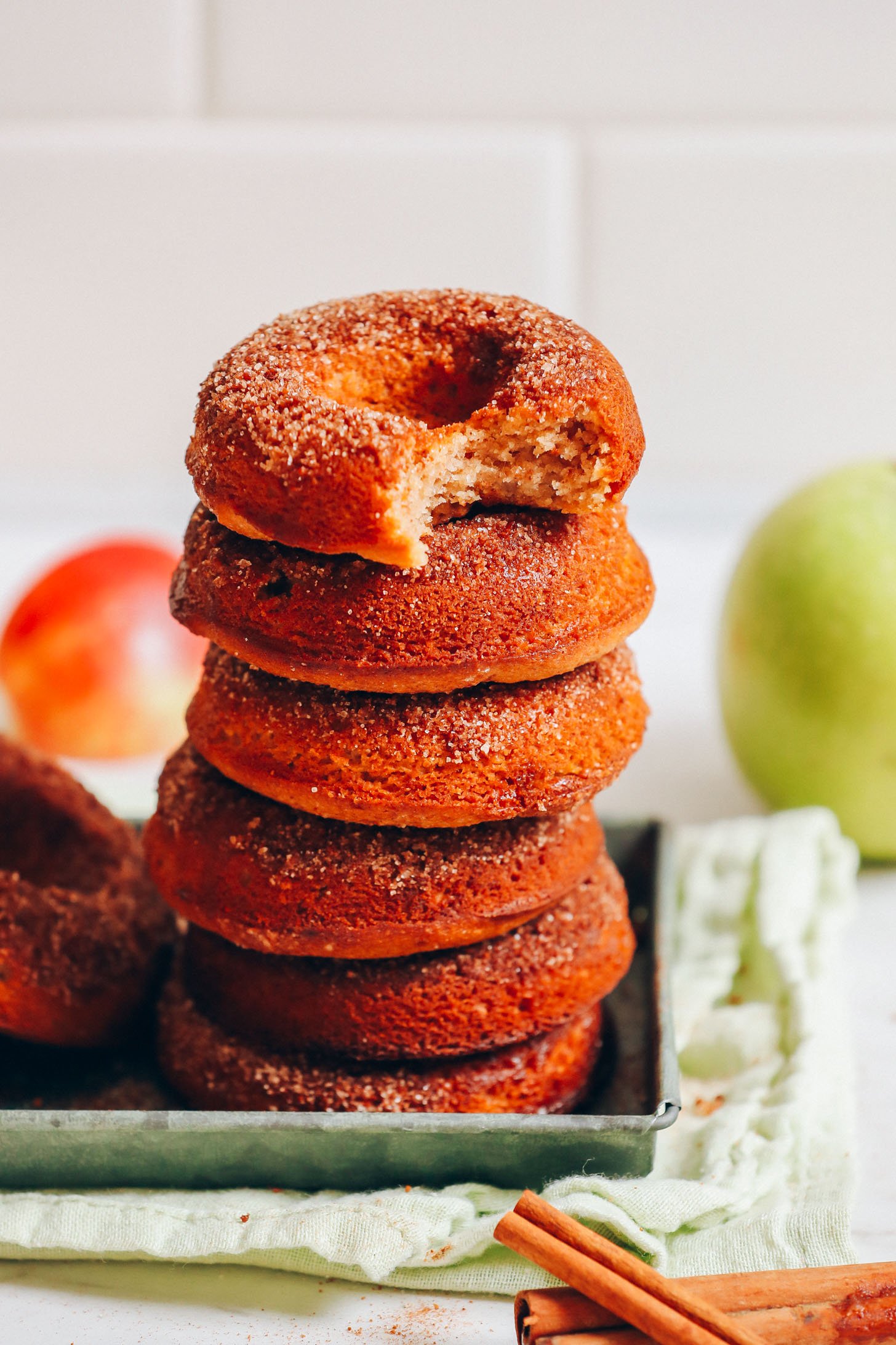 Stack of delicious Vegan Gluten-Free Apple Cider Donuts resting on a metal tray