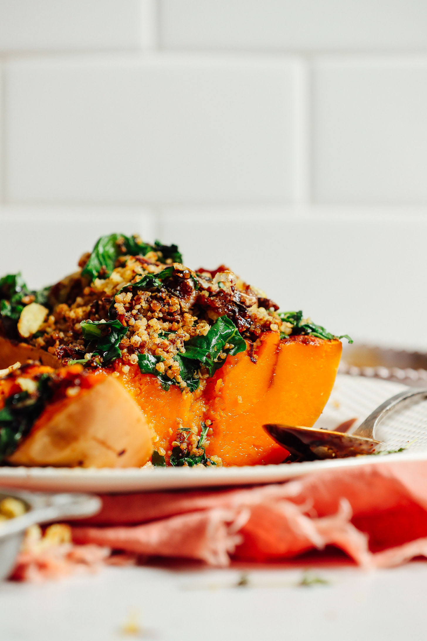 Close up shot of butternut squash stuffed with mushrooms, kale, and quinoa