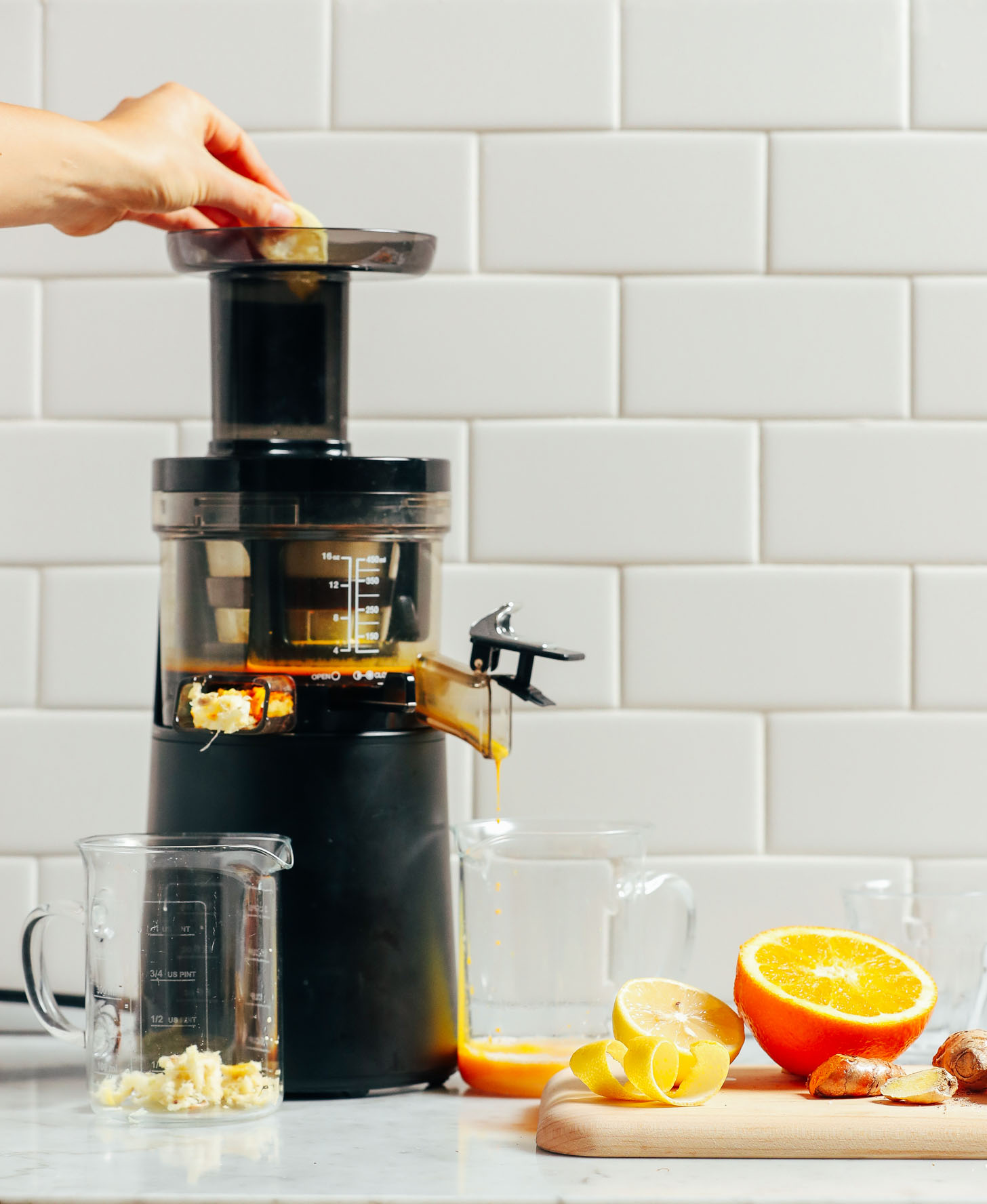 Showing how to use a juicer to make Turmeric Wellness Shots