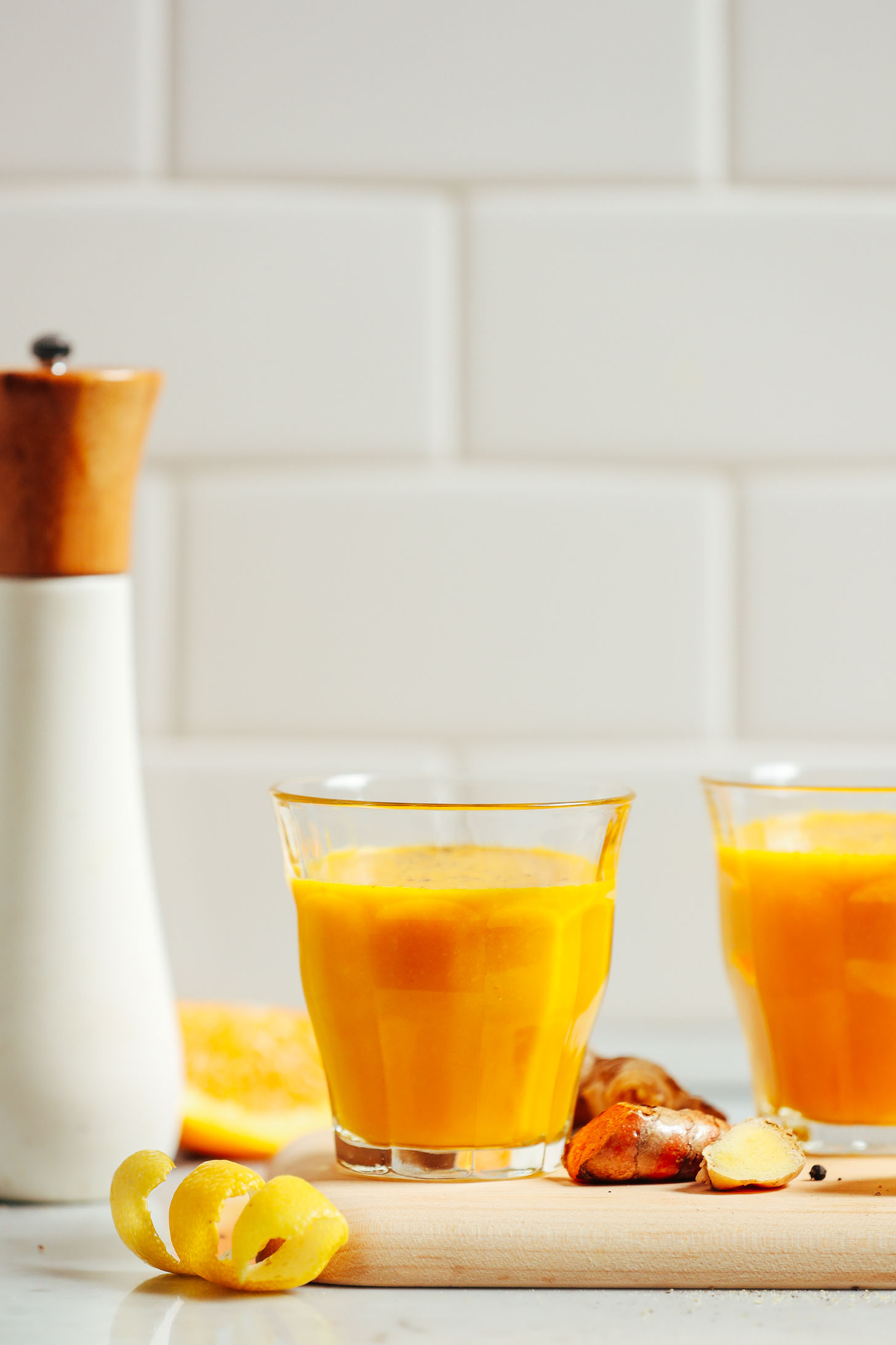 Turmeric Wellness Shots on a cutting board ready to drink for a healthy boost