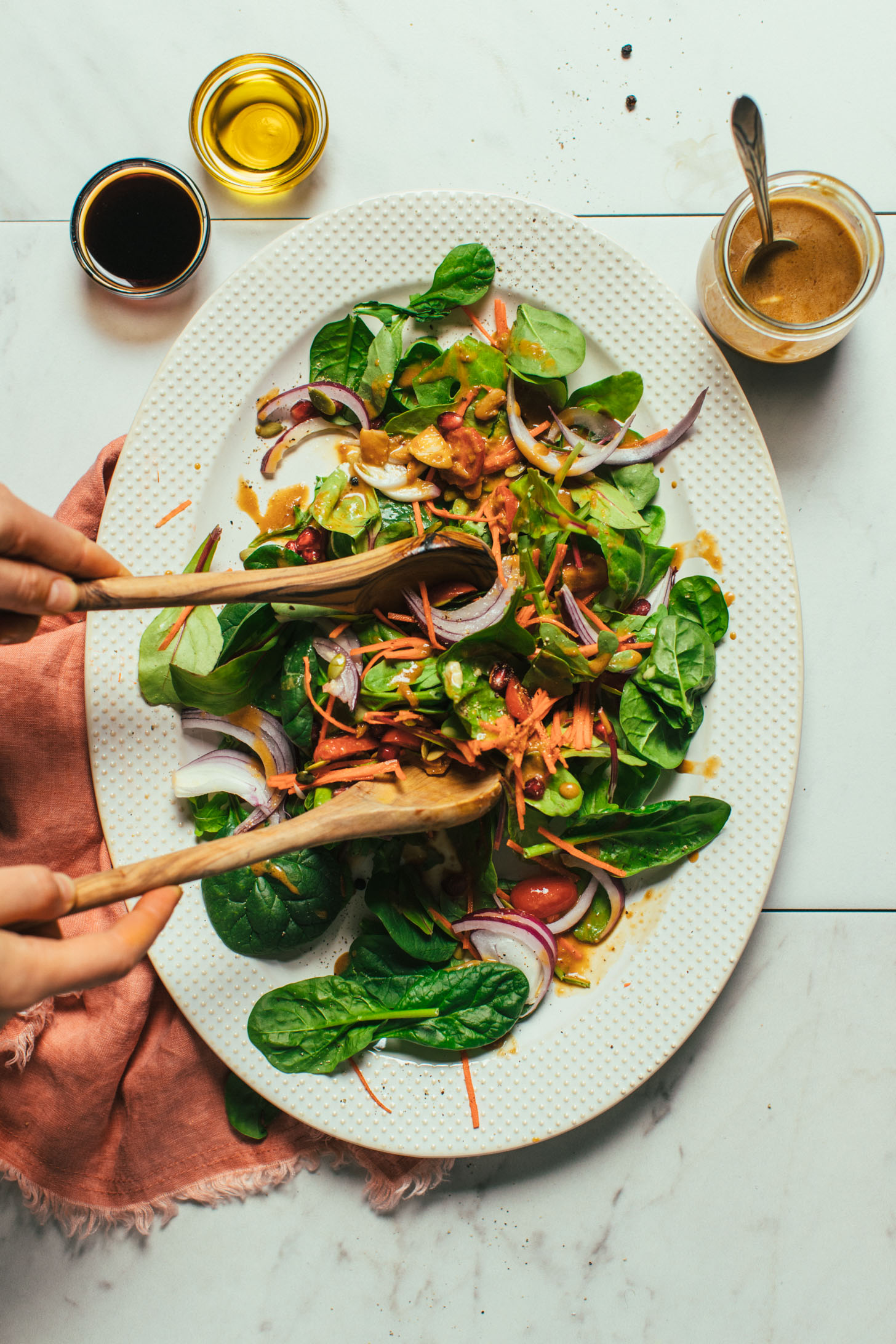Using wooden salad spoons to toss a salad with homemade Balsamic Vinaigrette Dressing