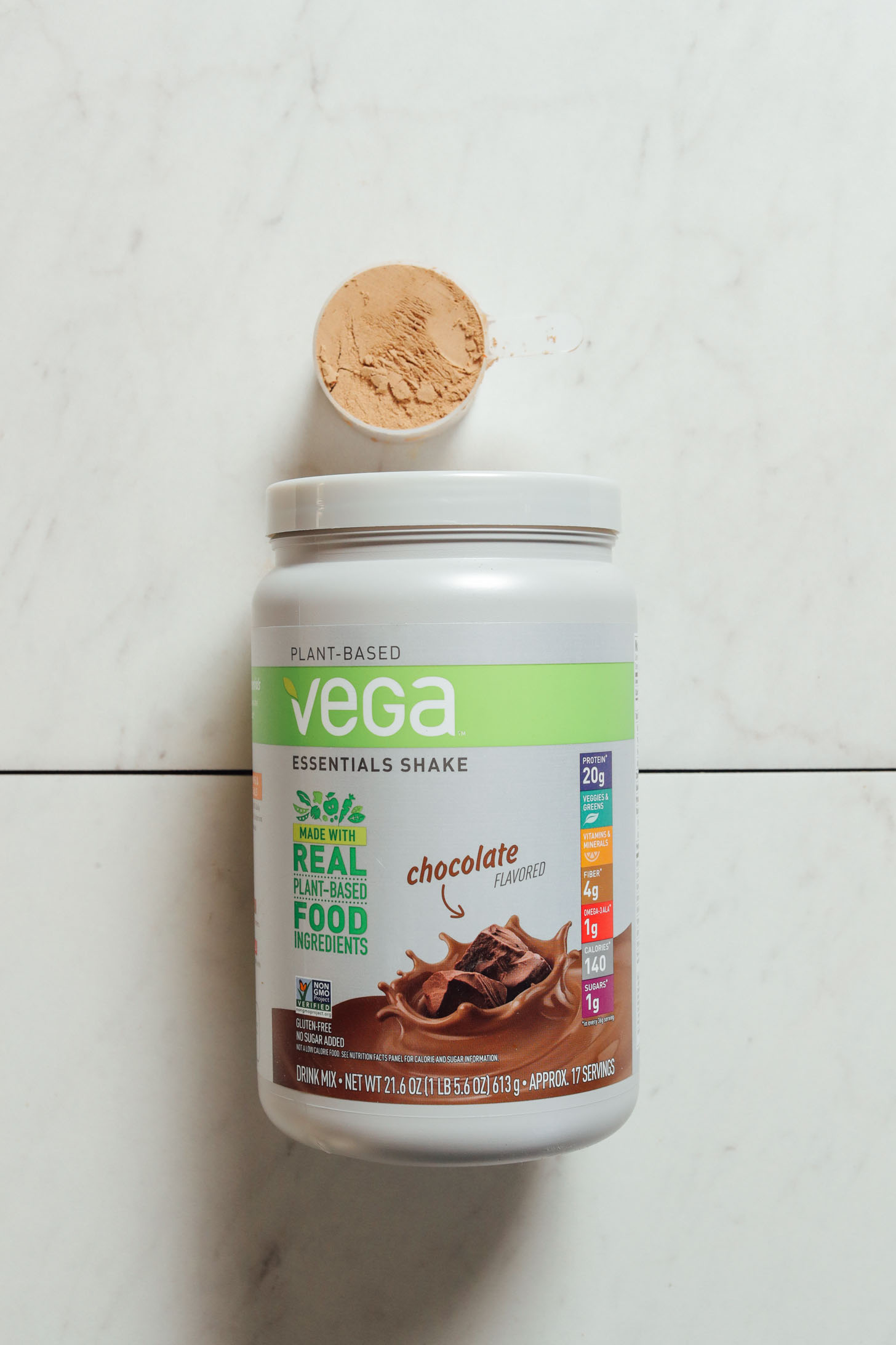 Tub and scoop of Vega Chocolate Protein Powder for our unbiased protein powders review